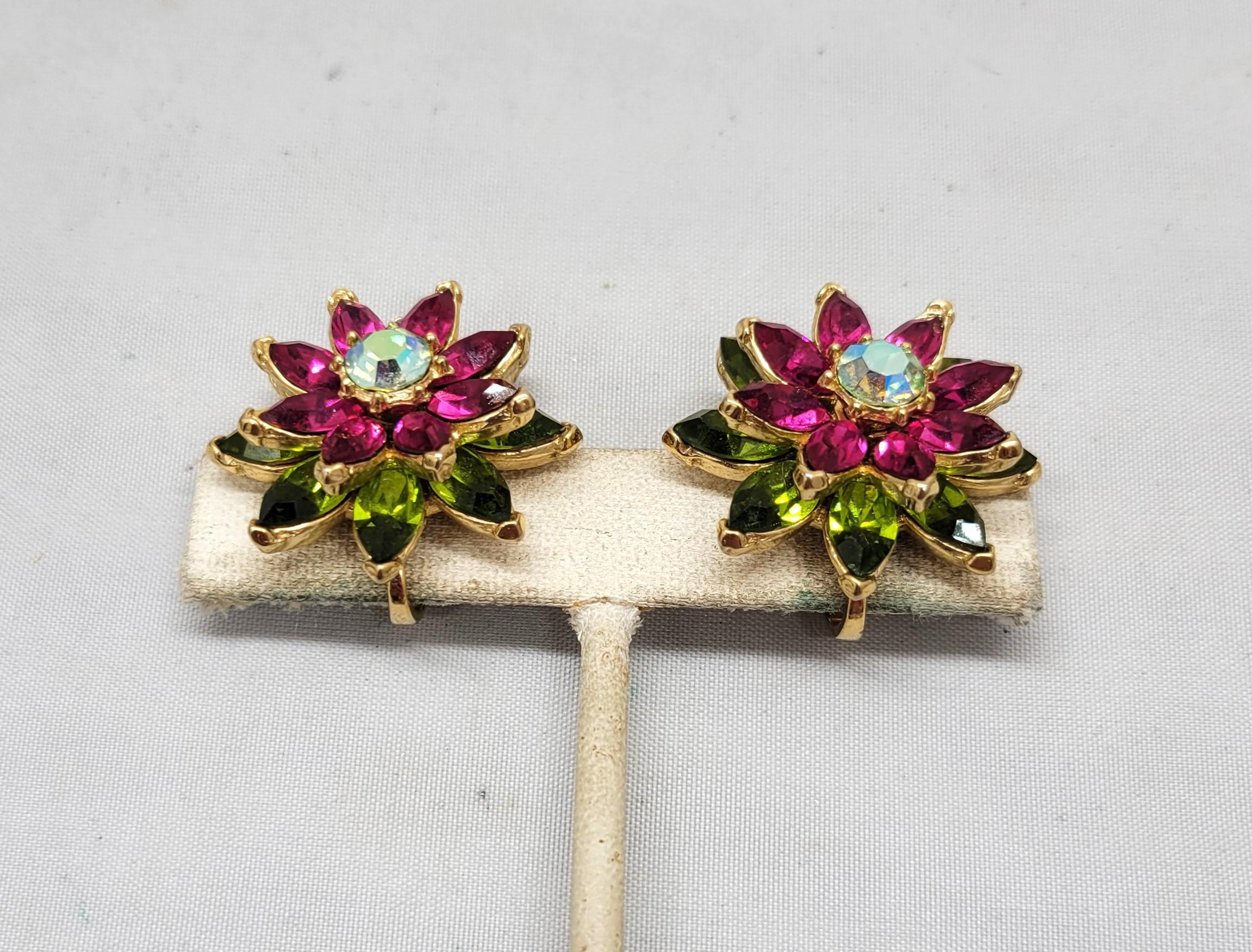 Circa 1961 goldtone marquise faux-peridot and faux-ruby with round green aurora borealis center flower clip earrings. Marked crown 