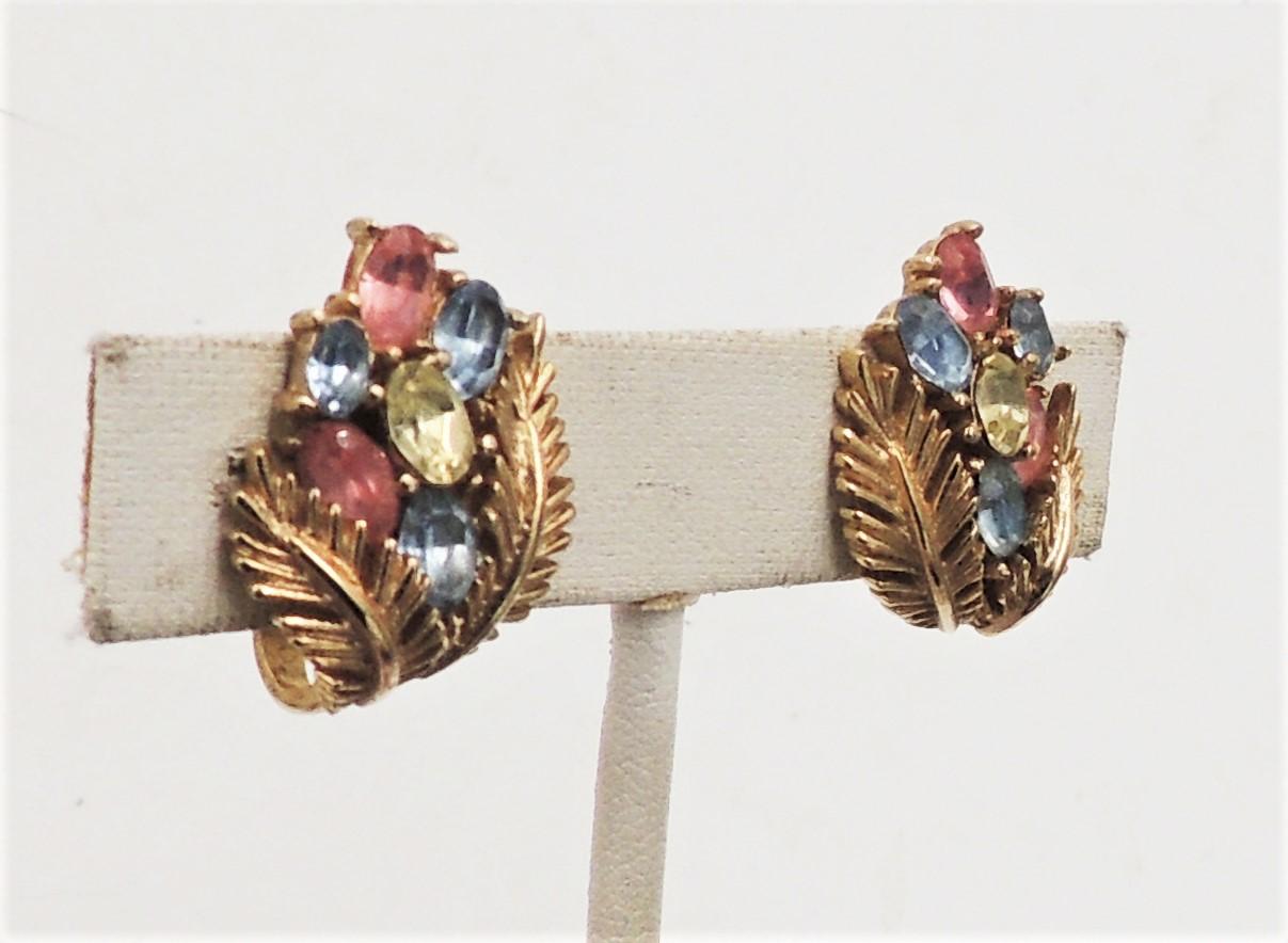 1960s goldtone leaves with pastel pink, blue and yellow oval rhinestones clip back earrings. Marked 