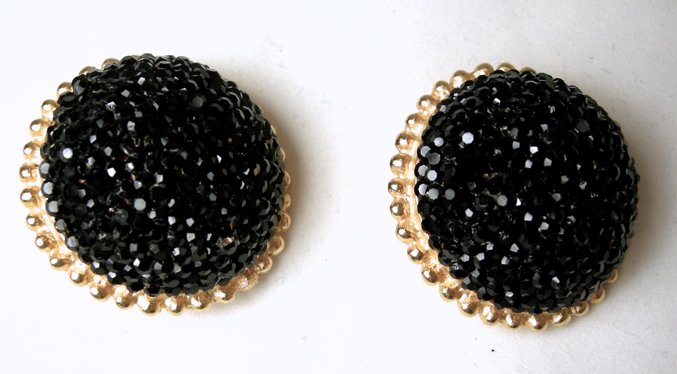 These vintage signed Deanna Hamro earrings have a dome design with black faceted crystals in a gold tone setting.  In excellent condition, these clip earrings measure 1-1/4” across/diameter and are signed “Deanna Hamro”.