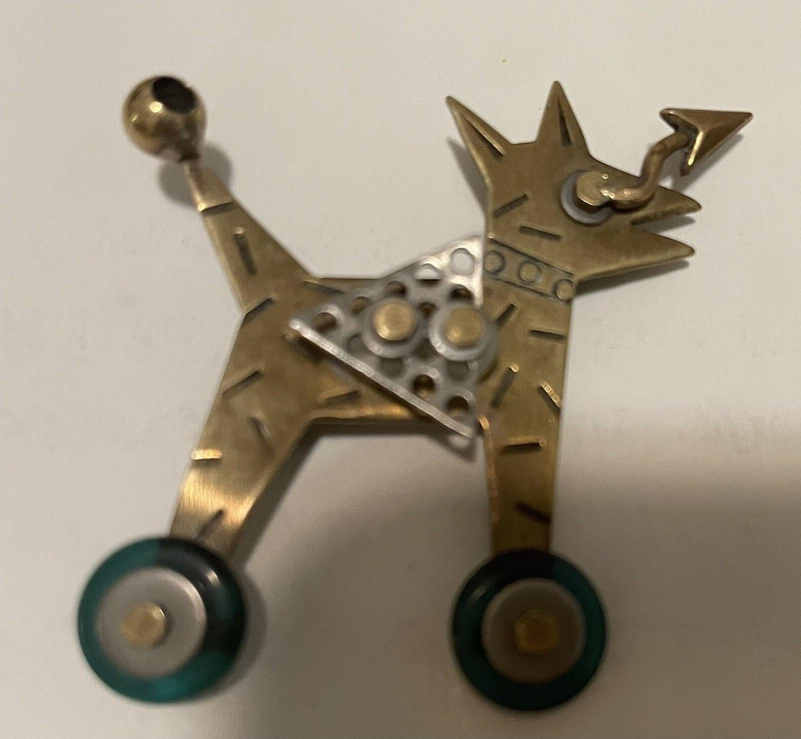 Simply Wonderful! Featuring Designer Thomas Man’s small Dog on Roller Skates Brooch. Crafted well-detailed Metal Art using mixed metals in Brass, Silver, Bronze. Measuring approx. 1.75” high x 1.75” wide. Signed on reverse. A piece sure to enhance