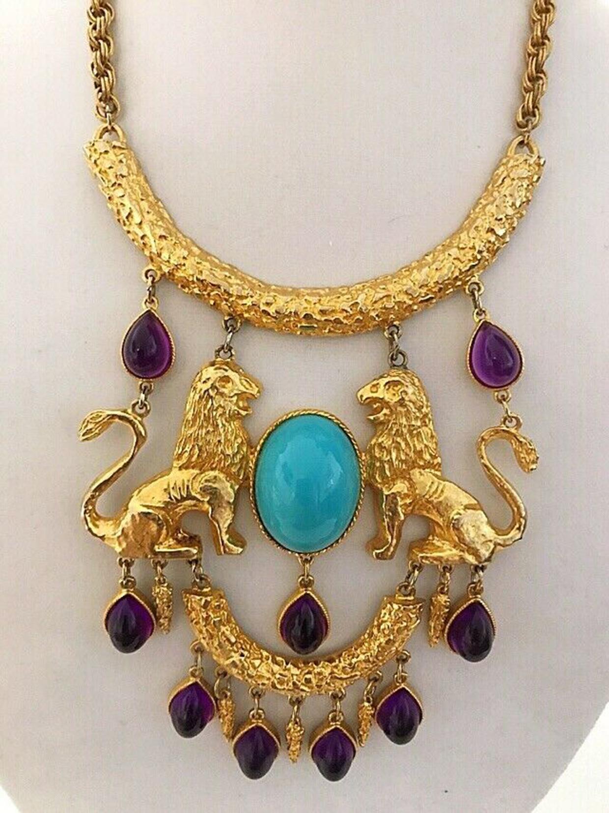 Spectacular Donald Stannard Iconic Twin Lions bib Necklace. Fabulous massive Book Piece Necklace adorned with a large oval shaped cabochon Turquoise Lucite and nine dangling tear drop shaped cabochon Amethyst Lucite; set in ornate gold plated