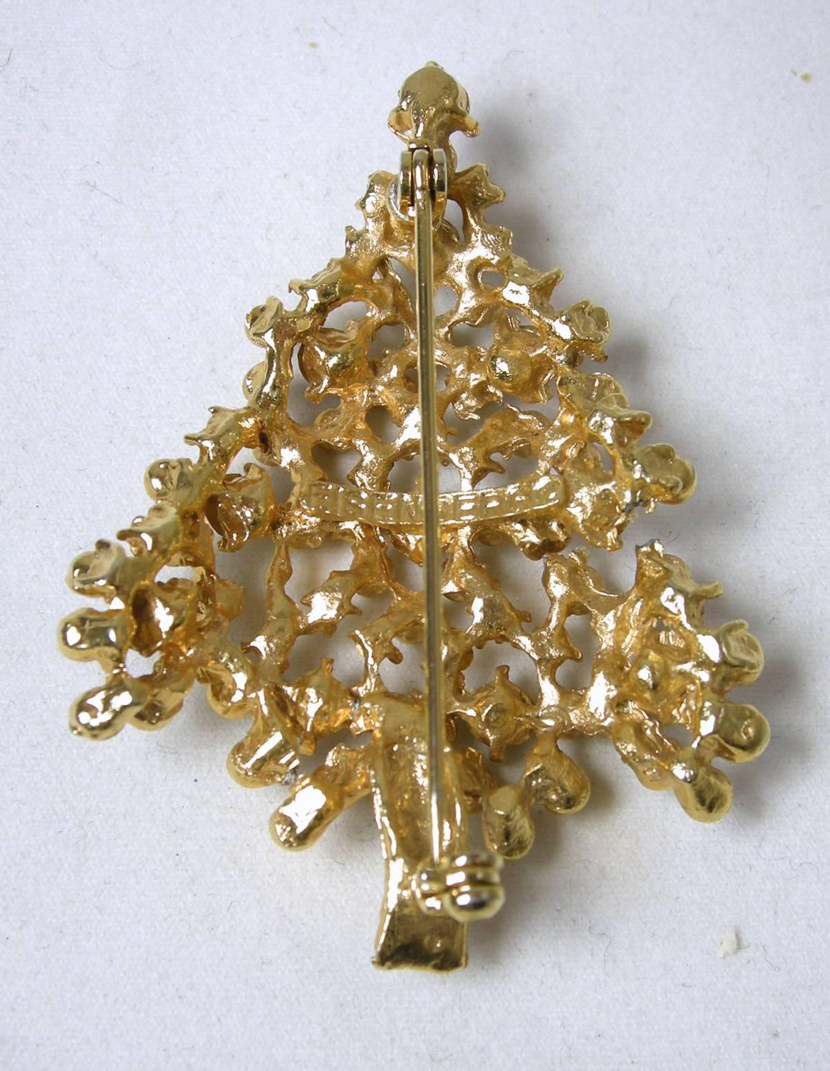 This is a wonderful Eisenberg Christmas tree with red, green, clear and blue rhinestones embedded into gold tone beads.  It measures 2” long x 1-1/2” at its widest point.  It is signed “Eisenberg” and is in excellent condition.