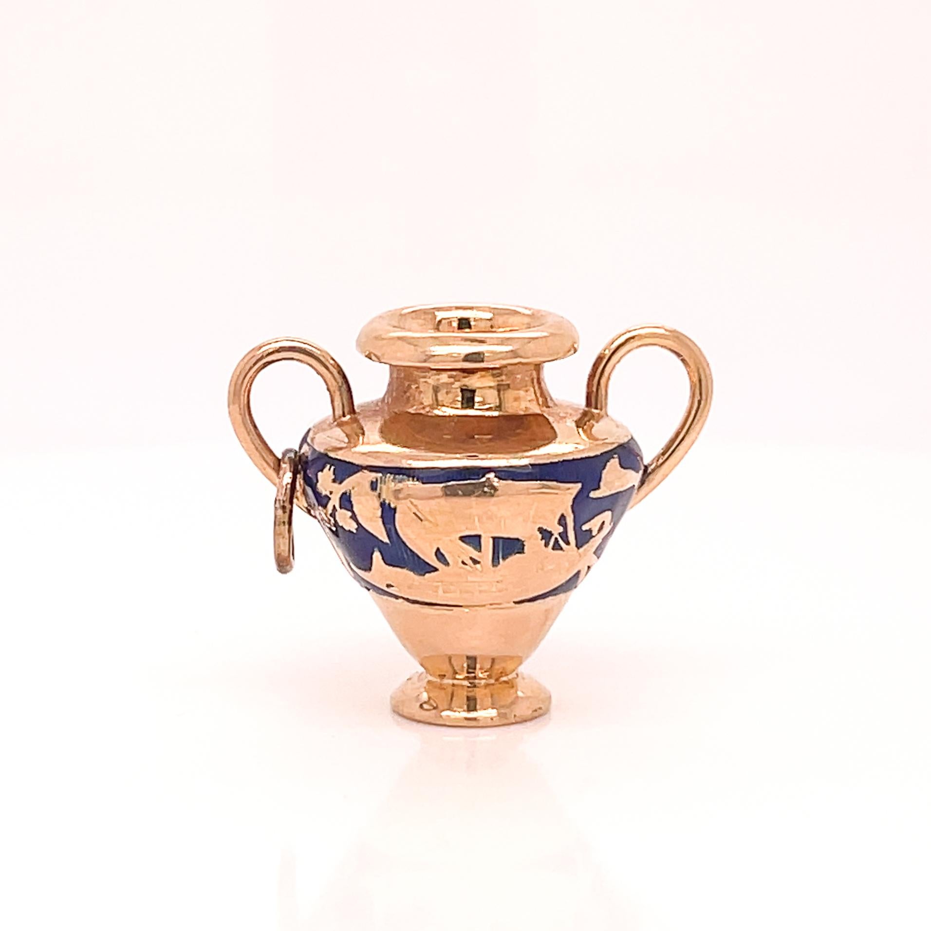 A very fine gold vase shaped charm or pendant.

With images of a ship and two greek soldiers in battle engraved around the vase and embellished with blue enamel.

Simply a great charm!

Date:
20th Century

Overall Condition:
It is in overall good,