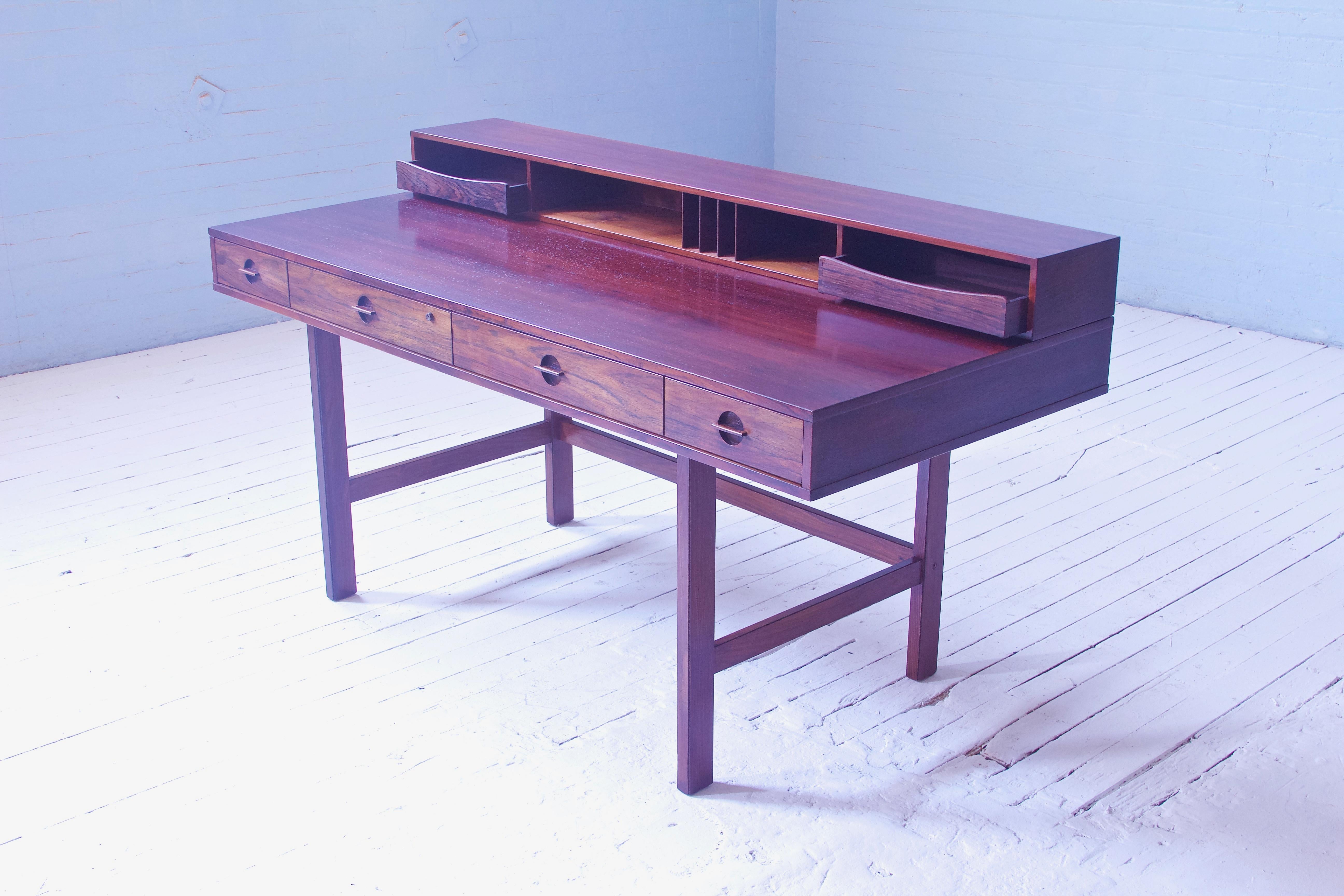 A supremely functional and aesthetically sophisticated desk in tropical hardwood by Peter Løvig-Nielsen for Løvig, Dansk, 1973. This piece contains the manufacturer's stamp [Løvig, Dansk] to underside of case, as well as the original