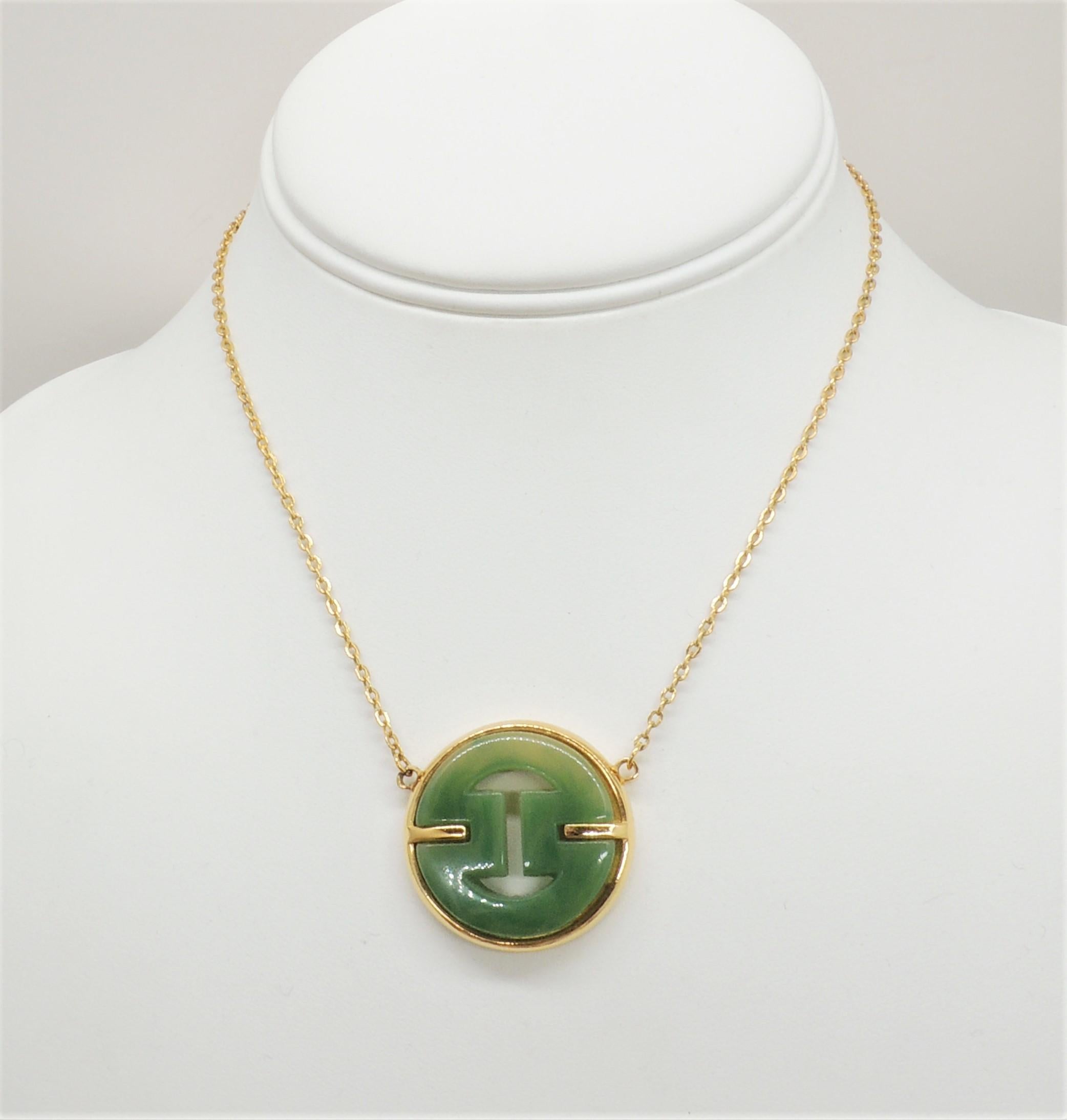 Goldtone Asian inspired faux-jade pendant necklace with spring ring clasp. Marked 