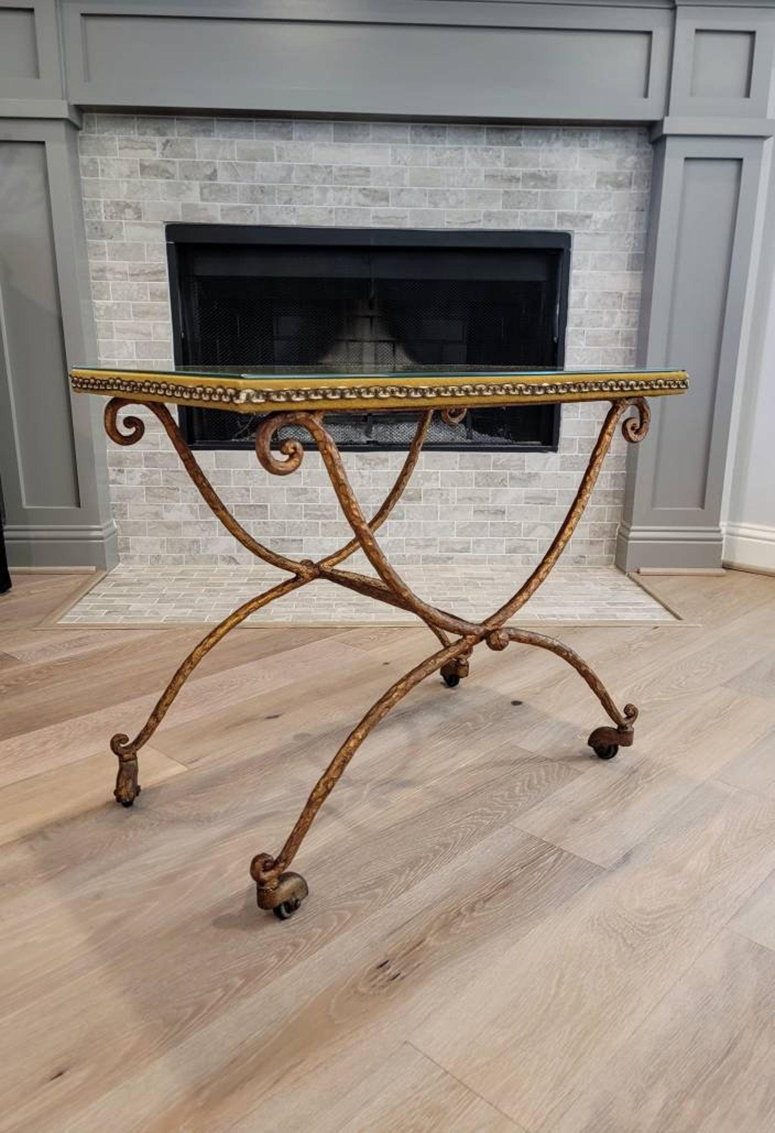 A stylish vintage, circa 1930s, hammered and patinated bronze-tone iron Italian Modernist table on casters. Signed, V.E.T. Meris. 

Hand-crafted in Italy in the early/mid-20th century, having a sculptural textured scrolled wrought iron curule