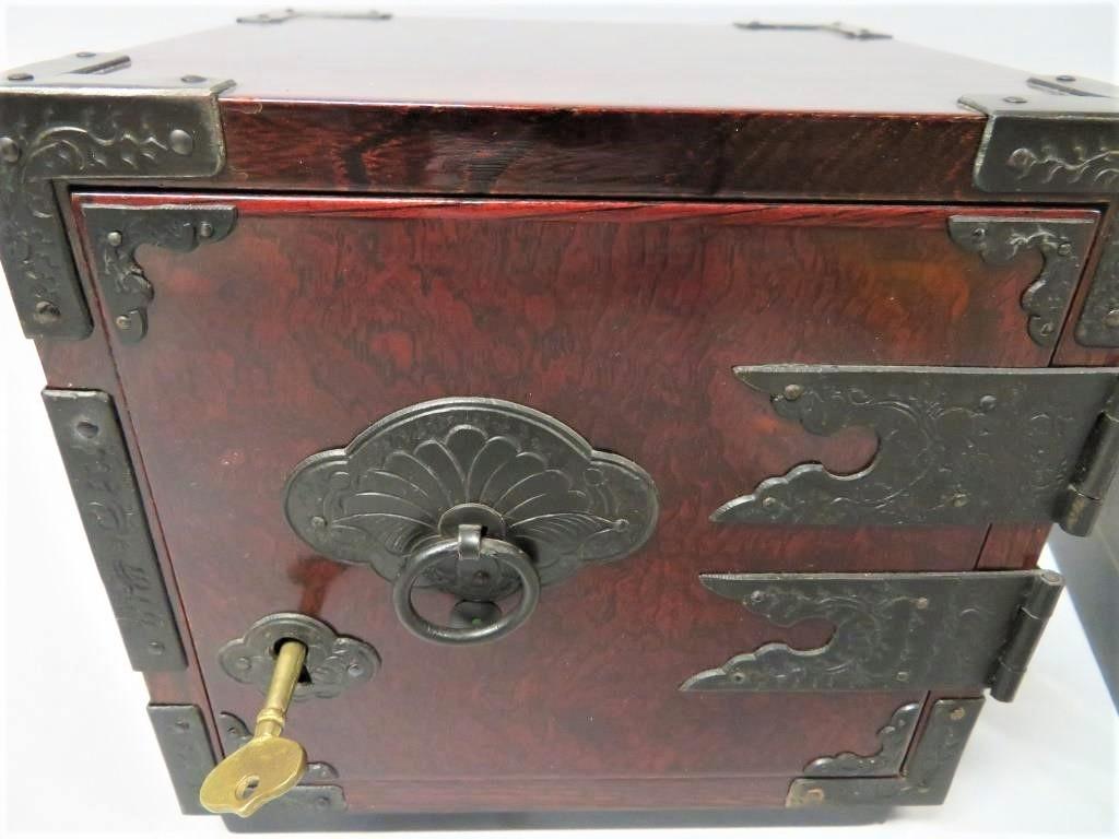 This signed Vintage Japanese exotic wood Kakesuzuri style funa dansu (ship's safe) is an fine example of the skilled craftsmanship of Sendai tansu makers. The smooth lacquer finish in reddish brown highlights the grain of this exotic wood, and the