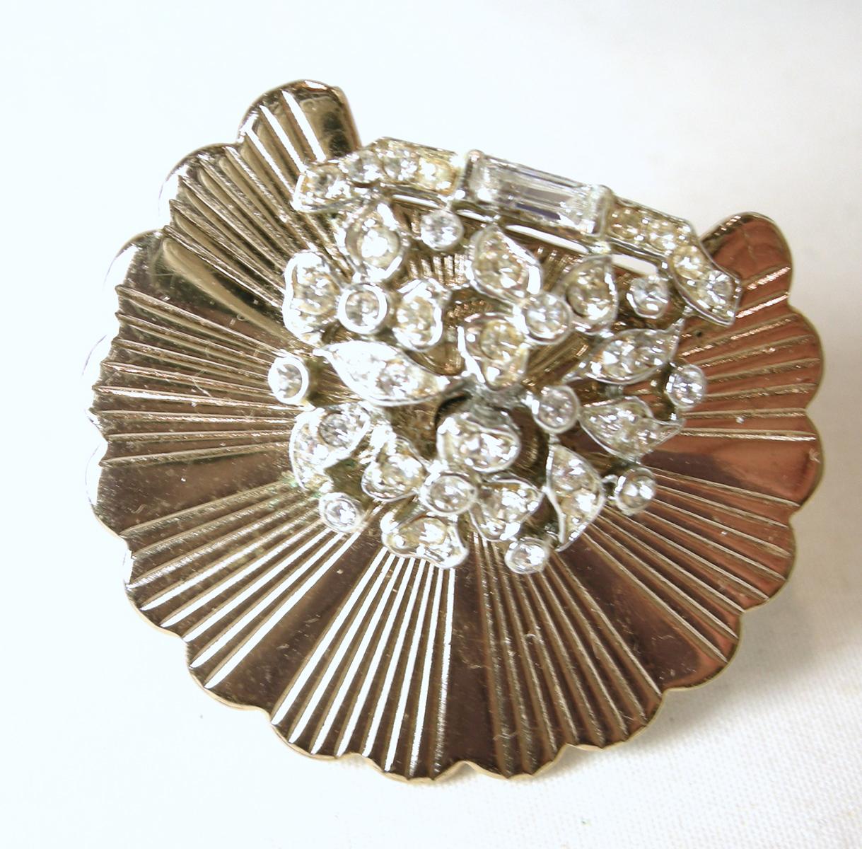 This vintage signed Marboux brooch and earrings set has a scallop design with different shaped crystals in the middle to top…in a gold tone setting.  The brooch measures 1-1/2” across/diameter.  The matching clip earrings are 1”.  In excellent
