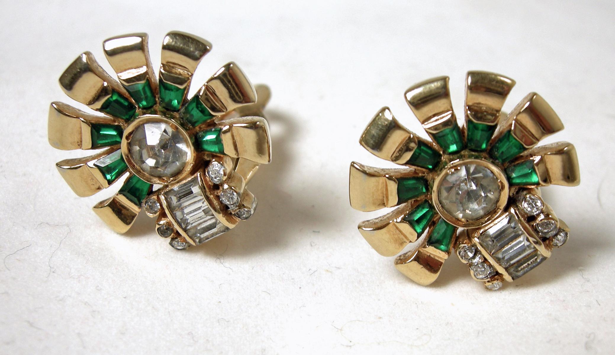 These vintage signed Mazer earrings have a retro design with green and clear crystals in a gold-tone setting.  In excellent condition, these clip earrings measure 3/4” across/diameter and are signed “Mazer”.