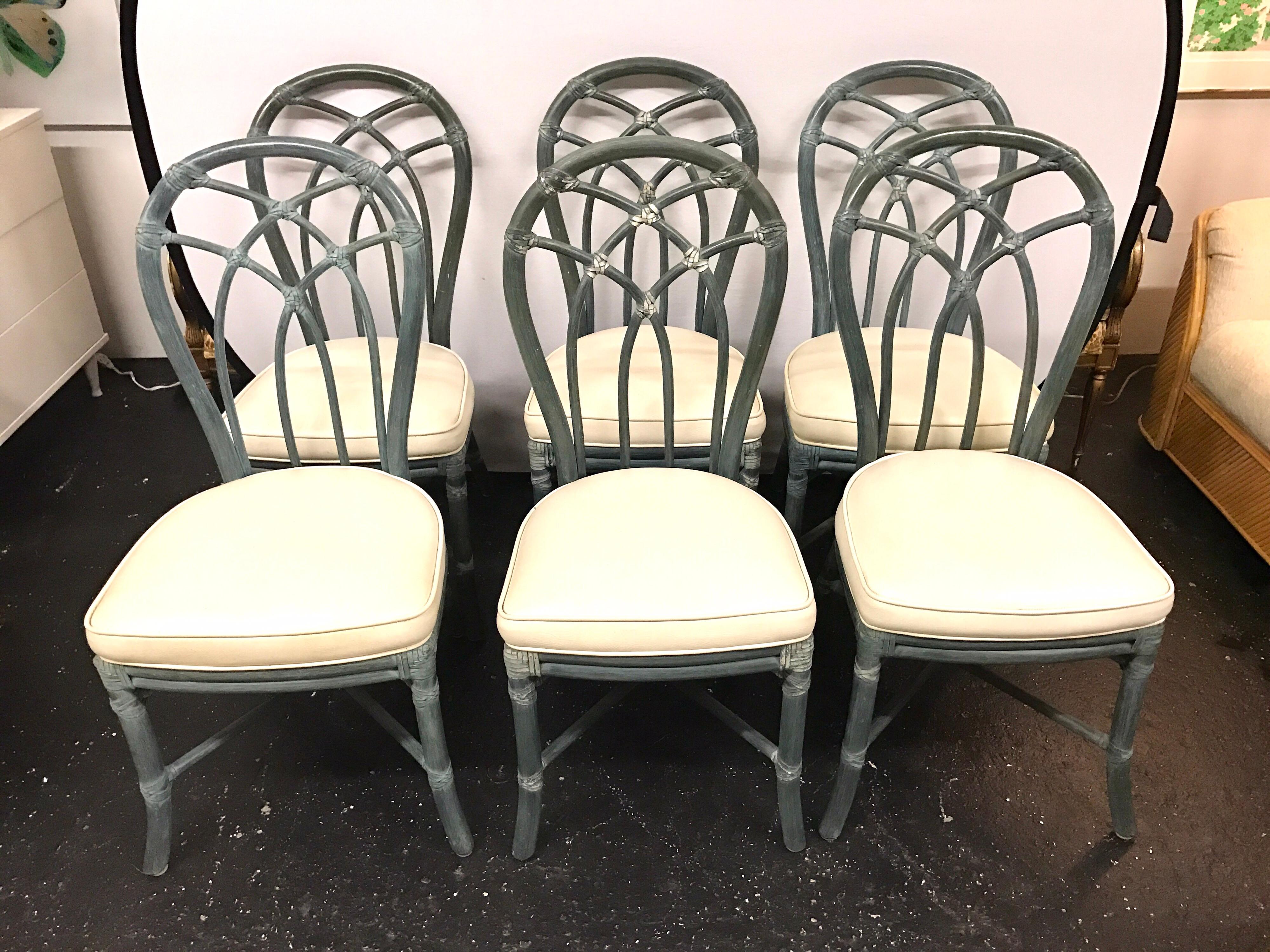 Set of six bamboo McGuire chairs in a painted blue gray finish and white faux leather seats. Brass McGuire plaque underneath seats. Excellent structural condition and only minor abrasions consistent with age.