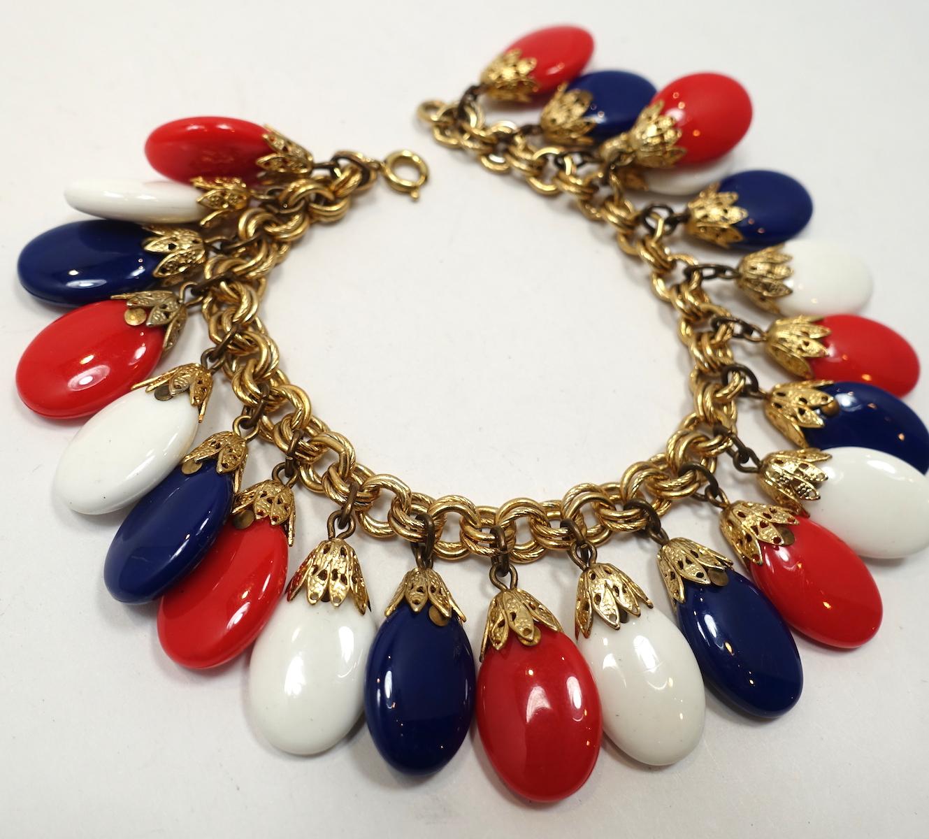 This vintage signed Napier bracelet features red, white and blue plastic drops in a gold tone setting.  In excellent condition, this bracelet measures 7-1/2” long with a spring closure. Each drop is 3/4” x 1/2” and is signed “Napier”.  It is in