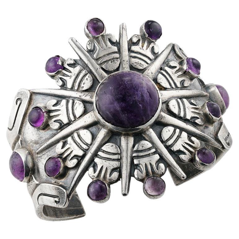 Simply Beautiful! Vintage Navajo Native American Mid Century Modern Sterling Silver Amethyst Cuff Bracelet. Centering an 18.8mm Cabochon Amethyst. Featuring Hand crafted embossed abstract Sun designs in Sterling Silver, radiating to Hand set