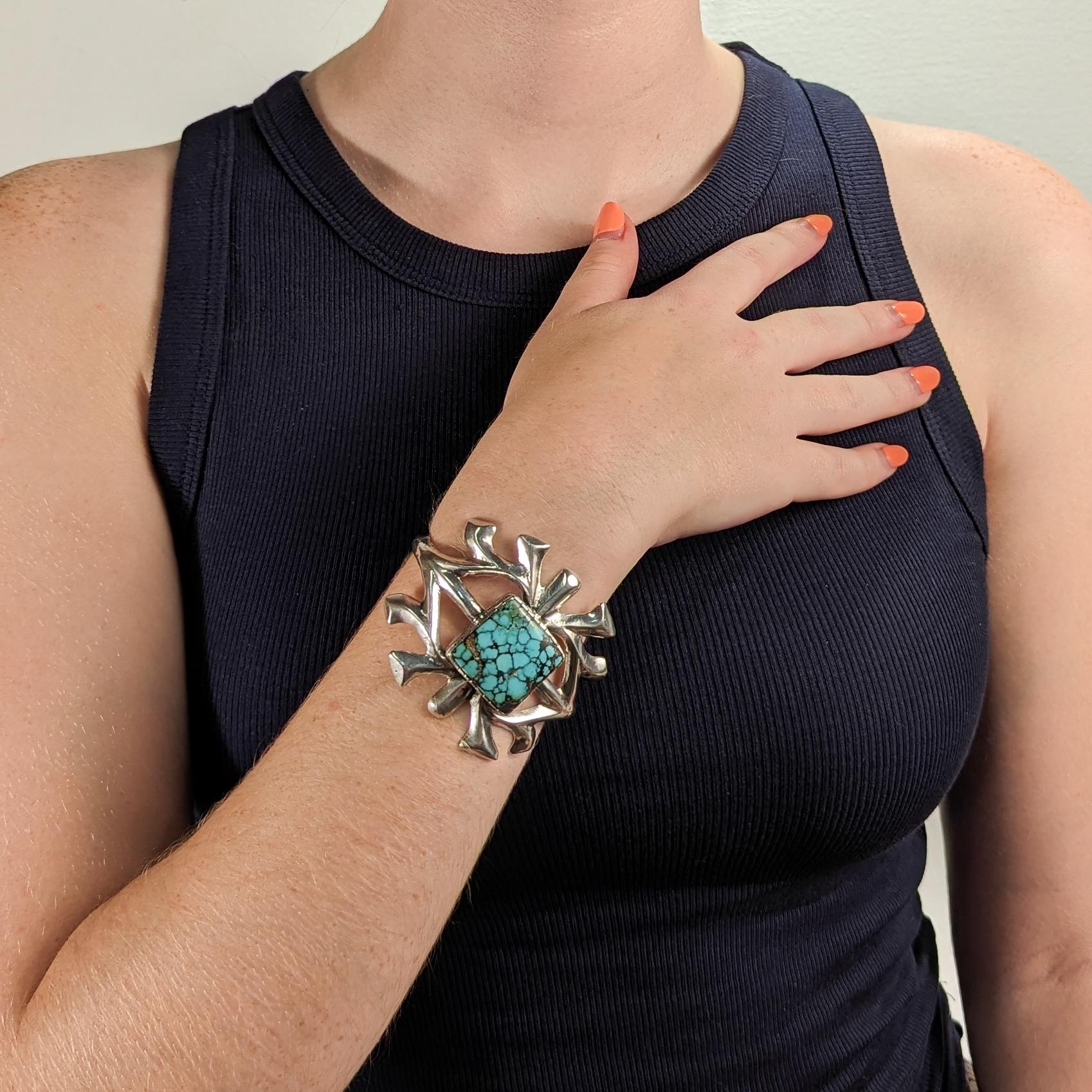 A fine Navajo silver and turquoise cuff bracelet.

Center set with a square shaped matrix turquoise cabochon.

Signed to the reverse for Sterling / Peter John / and with another hard to decipher mark.

Simply a wonderful piece of Old Pawn
