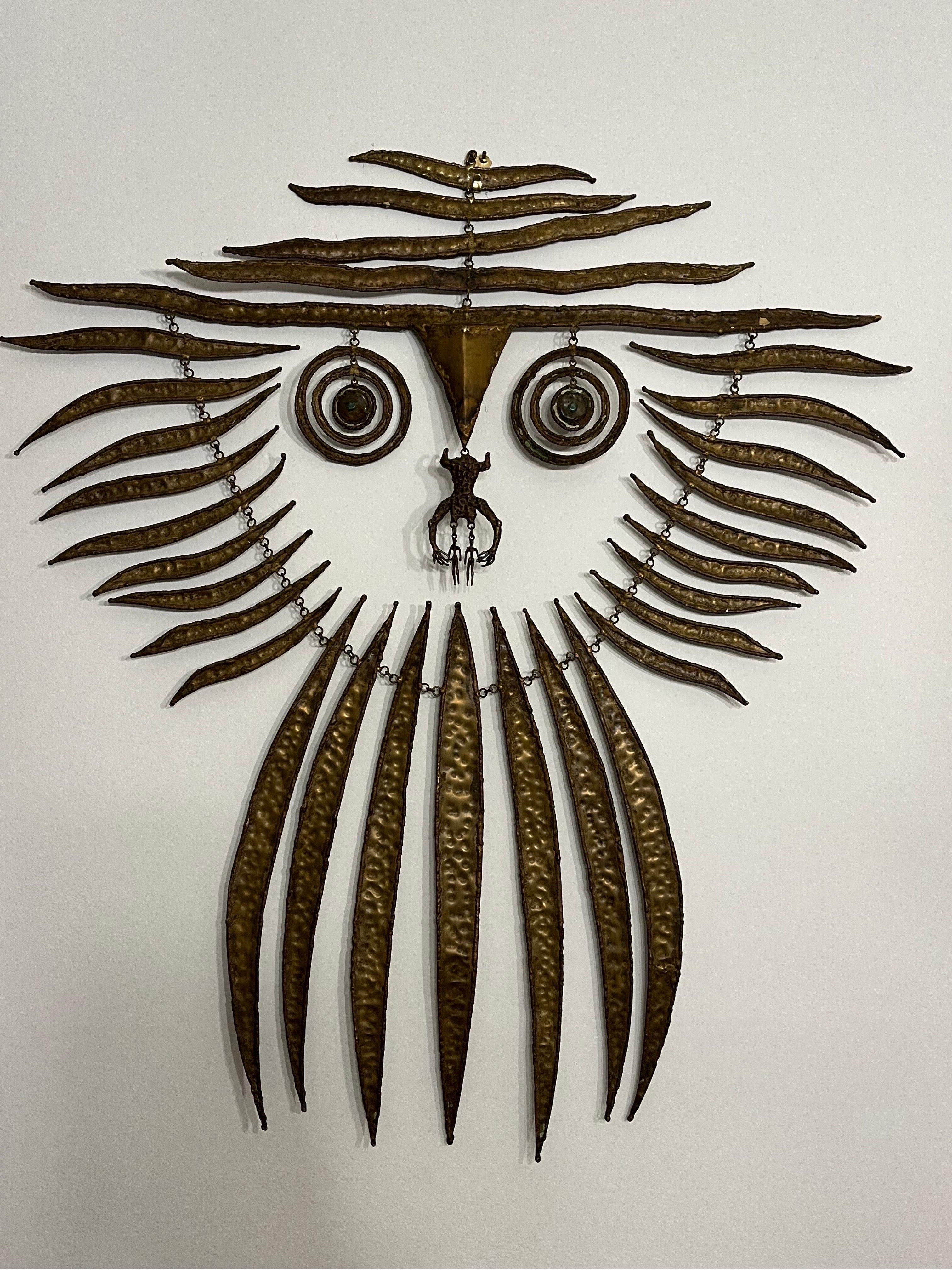 A mid century era, circa 1960’s, sculpted bronze kinetic hanging sculpture by Hungarian artist Pal Kepenyes (1926 - 2021). The abstracted figure has a surround like an elongated mane. The points radiating from the central face. The eyes are