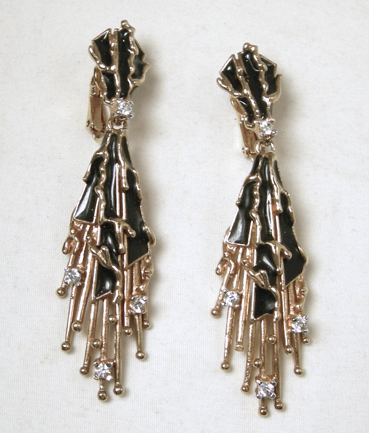 This vintage signed Panetta earrings has black enameling with clear crystal accents in a gold tone setting.  In excellent condition, these clip earrings measure 2-1/2” x 5/8” and are signed “Panetta”.