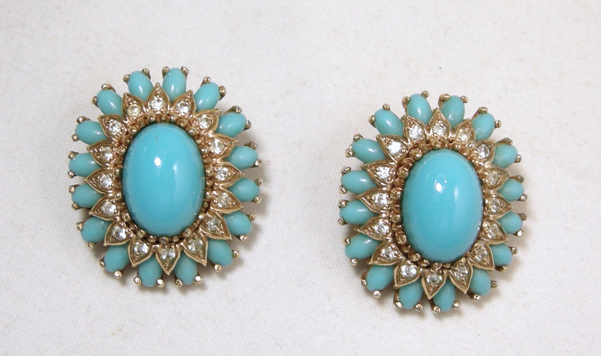 These vintage signed Panetta earrings has a faux turquoise center with smaller faux turquoise and clear crystal on the outside. It is in a gold tone setting.  In excellent condition, these clip earrings measure 1-1/8” x 1” and are signed “Panetta”.