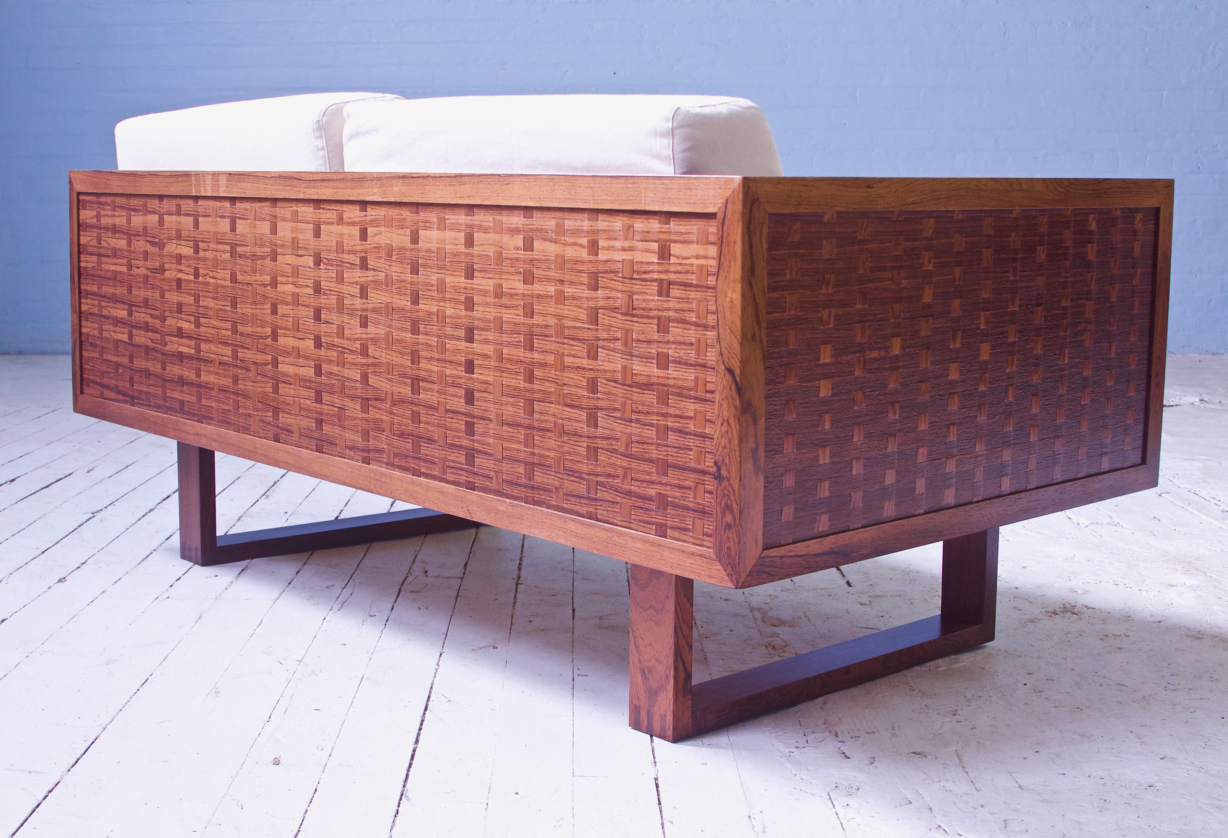Up for sale we have a wonderful pair of rare 'basketweave' settees in rosewood by the celebrated Danish designer Poul Cadovius, manufactured by France and Son, circa 1960 (applied manufacturer's label affixed to underside of both examples).

These