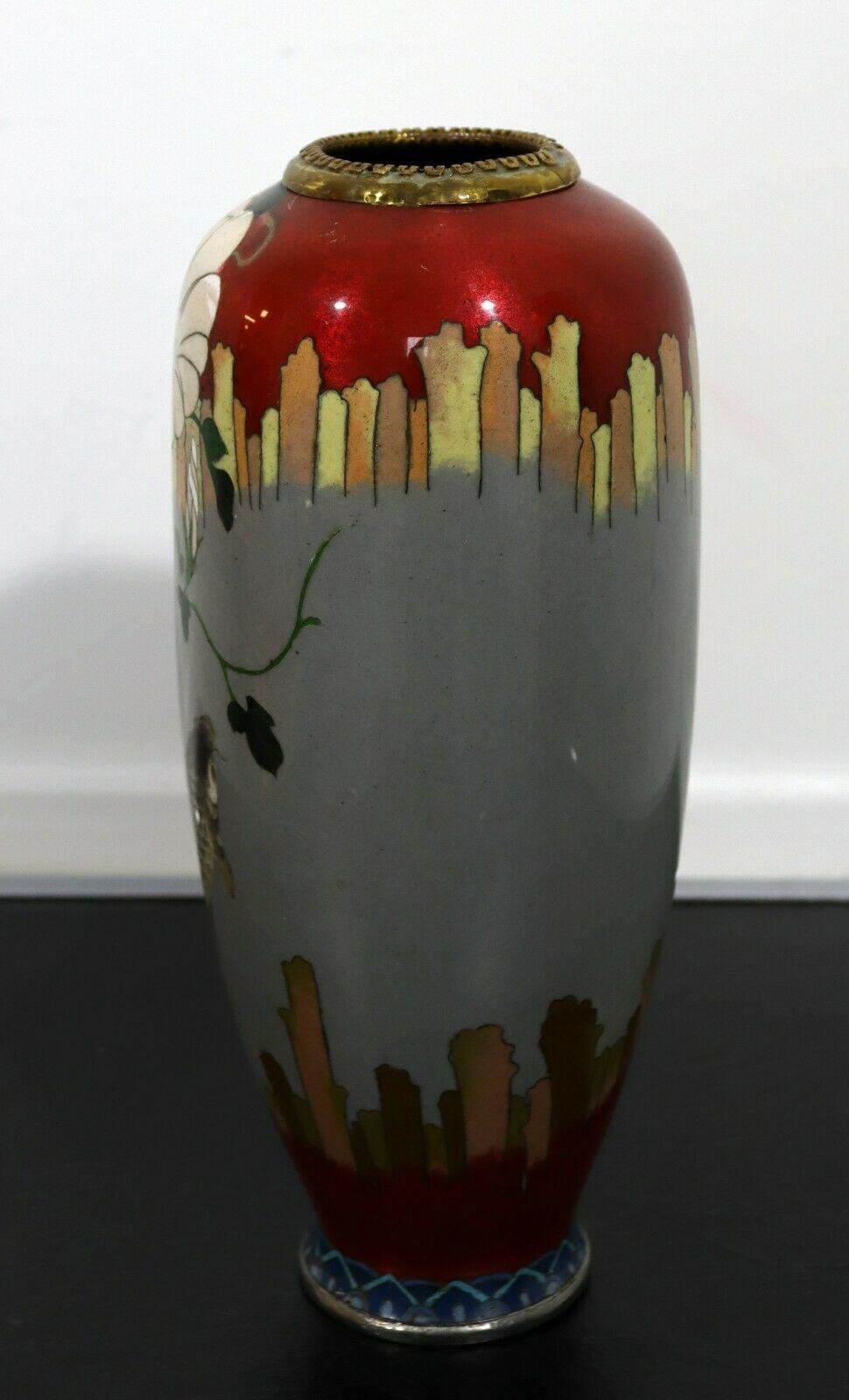A stunning vintage vase that is made with enameled cloisonne. The design is depicting a lovely koi fish imagery. In excellent condition. Dimensions: 11