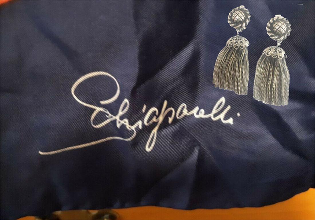 Fabulous Vintage Schiaparelli Tassel clip-on Dangle Earrings; each earring features a circular design raised disc from which drops a tassel with segmented cap; silver tone; the signature script “Schiaparelli” and number are located on the reverse
