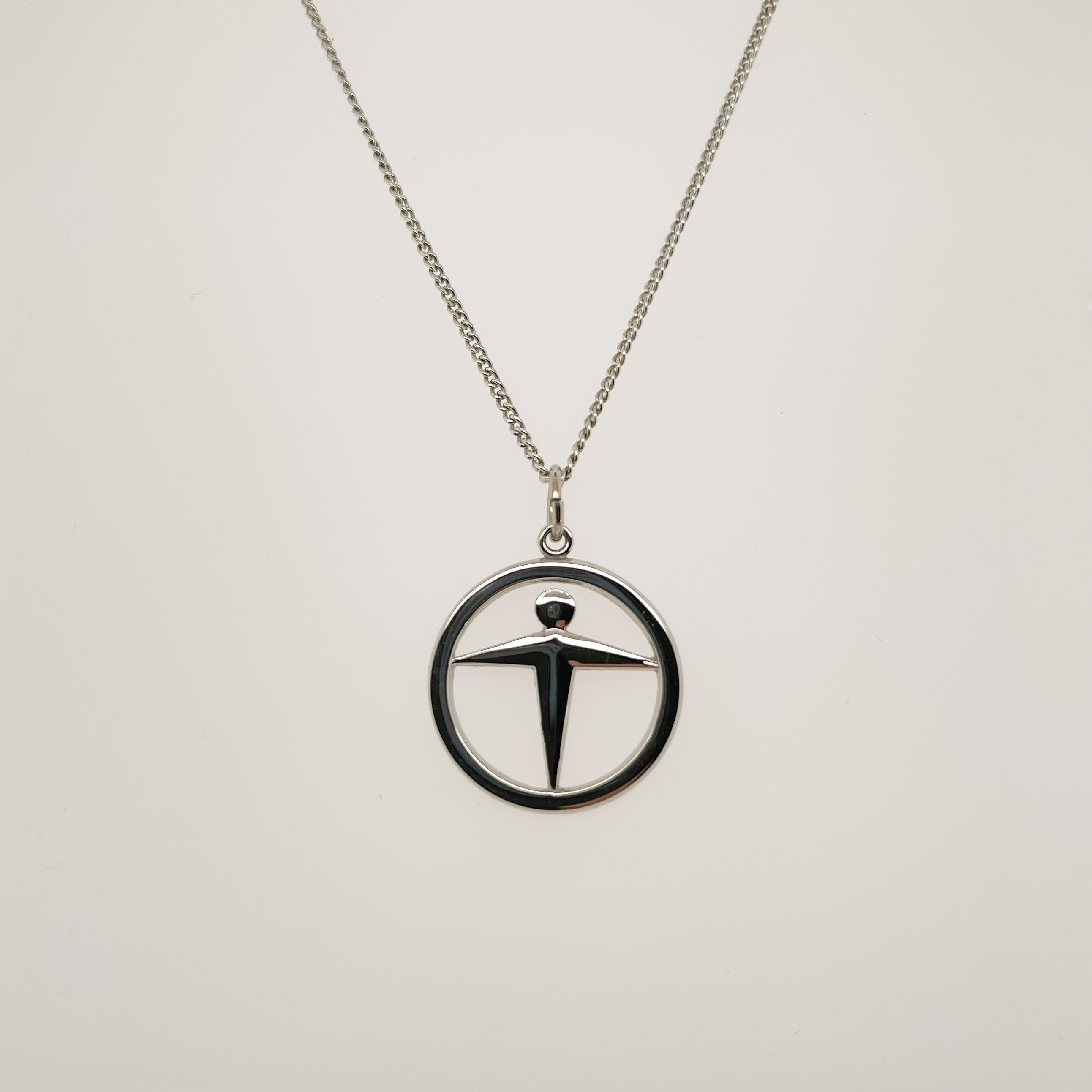 A fine Tiffany & Co. Manpower pendant.

In sterling silver. 

Together with a non-Tiffany associated sterling silver chain.

Date:
21st Century

Overall Condition:
It is in overall good, as-pictured, used estate condition with some very fine & light