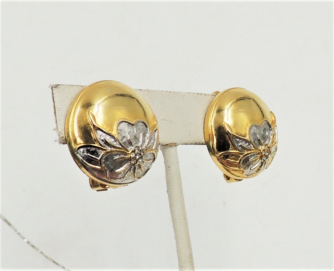 1980s round goldtone and brushed rhodium plate flowers with tiny clear round rhinestone accents clip back earrings. Marked 