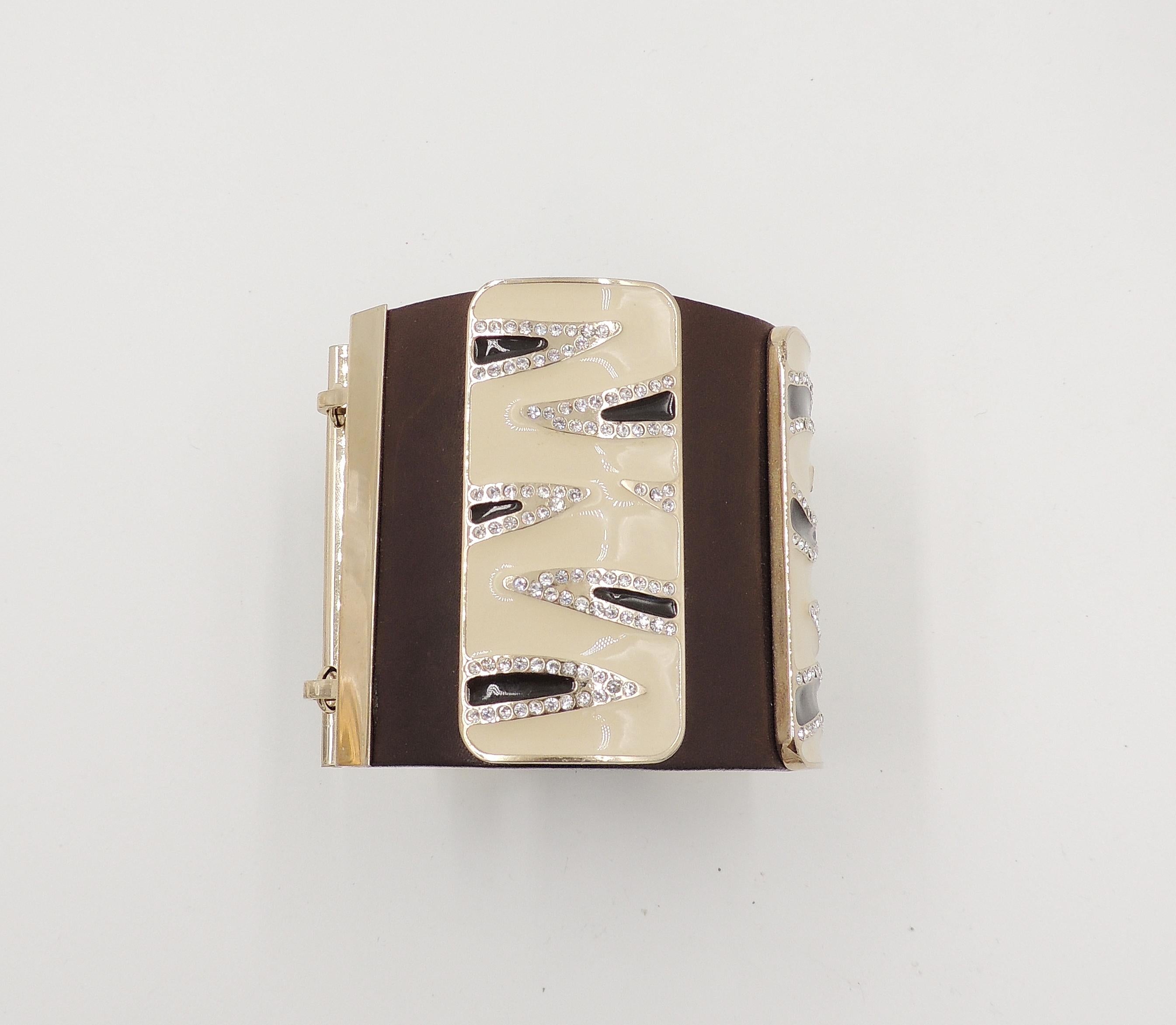 1980s or 90s gold plated leather with three zebra stripe black and white enamel plaques and rhinestone accents cuff bracelet with double hook clasp. Marked with Valentino Garavani's 