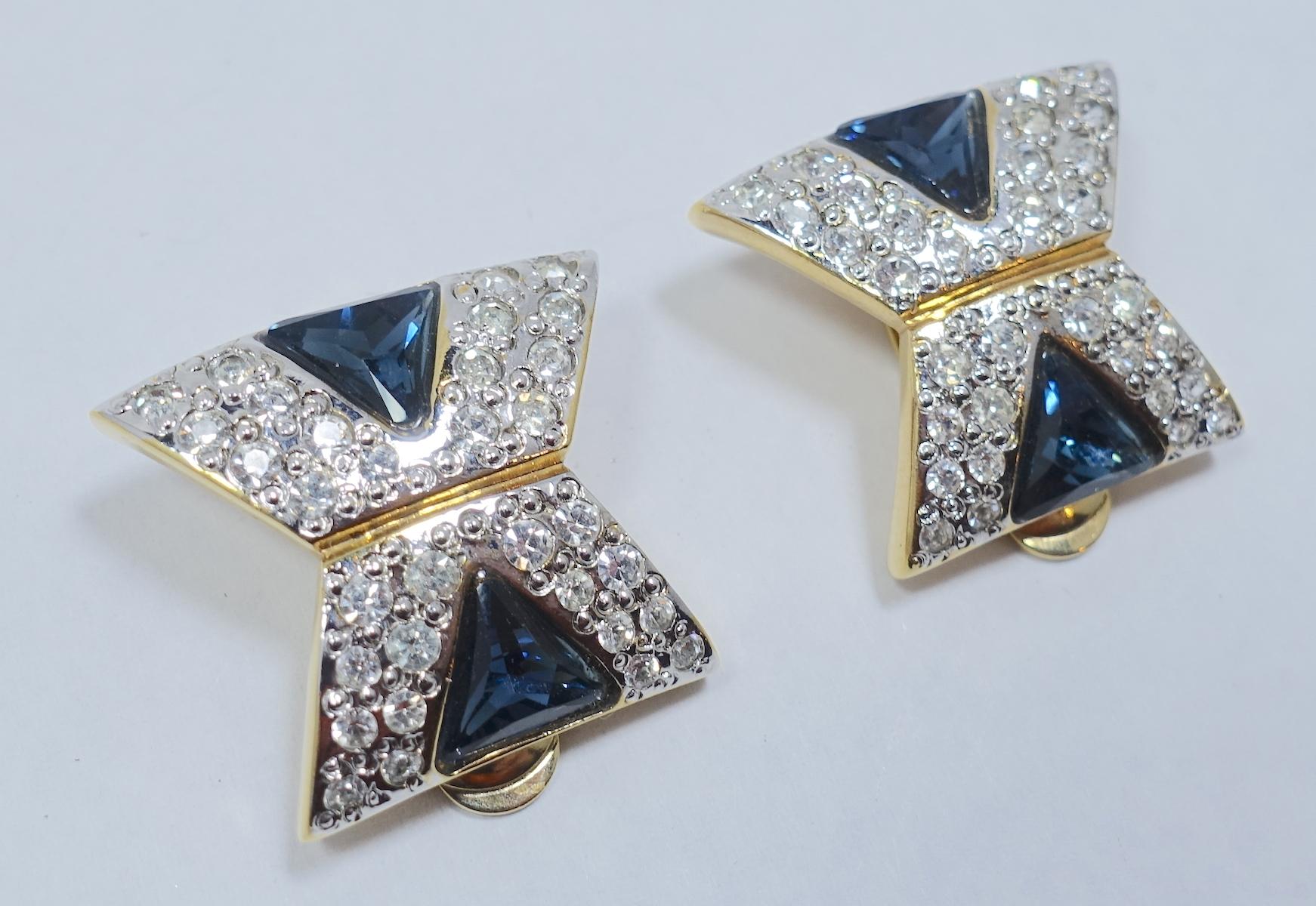 It is hard to tell these vintage earrings are costume; they are that well made. They are designed with brilliant blue and clear crystals in a gold tone setting.  These clip earrings measure 1” x 7/8” and are signed “Vogue Bijoux”. They are in