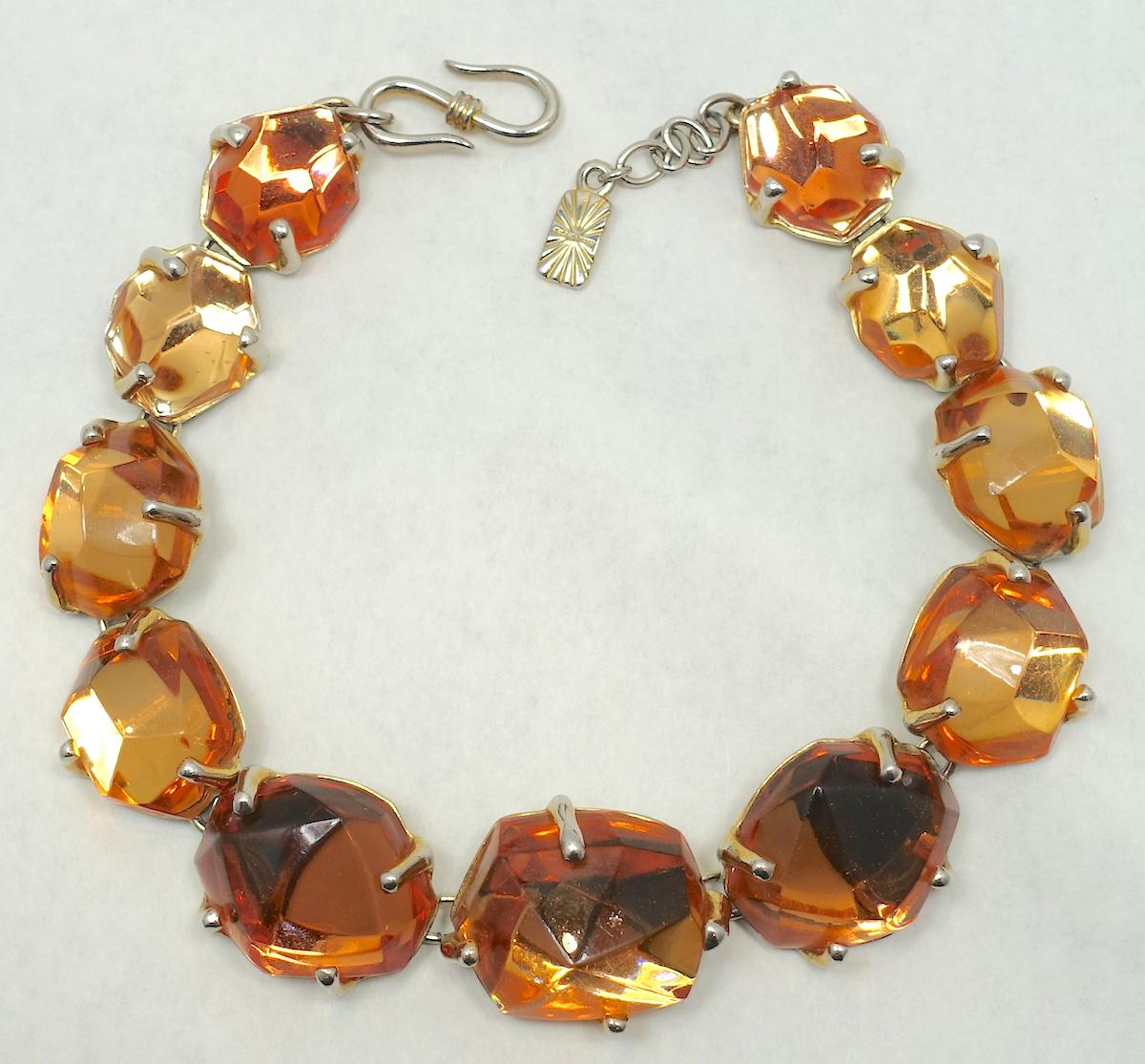 This dramatic vintage signed Yves St. Laurent necklace has large citrine prong set crystals in a silver tone setting.  In excellent condition, this necklace measures 16” with a hook closure x 1-1/8” and is signed “YSL Made in France”.