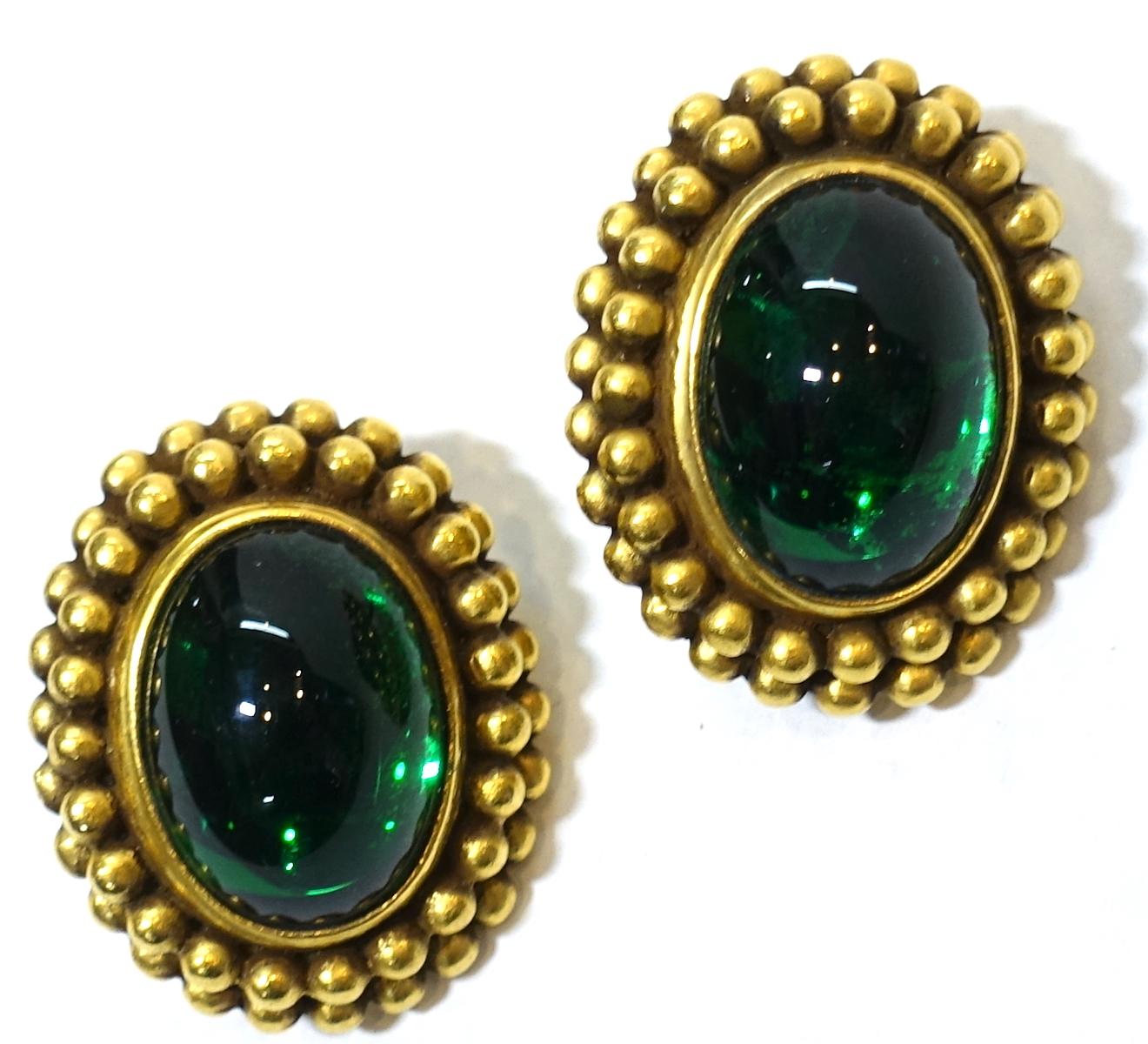 These vintage signed Yves St. Laurent earrings have a large green Gripoix glass center that is bezel in a ribbed gold tone border.  These clip earrings measure 1-1/4” x 1” and are signed “YSL”.  They are in excellent condition.
