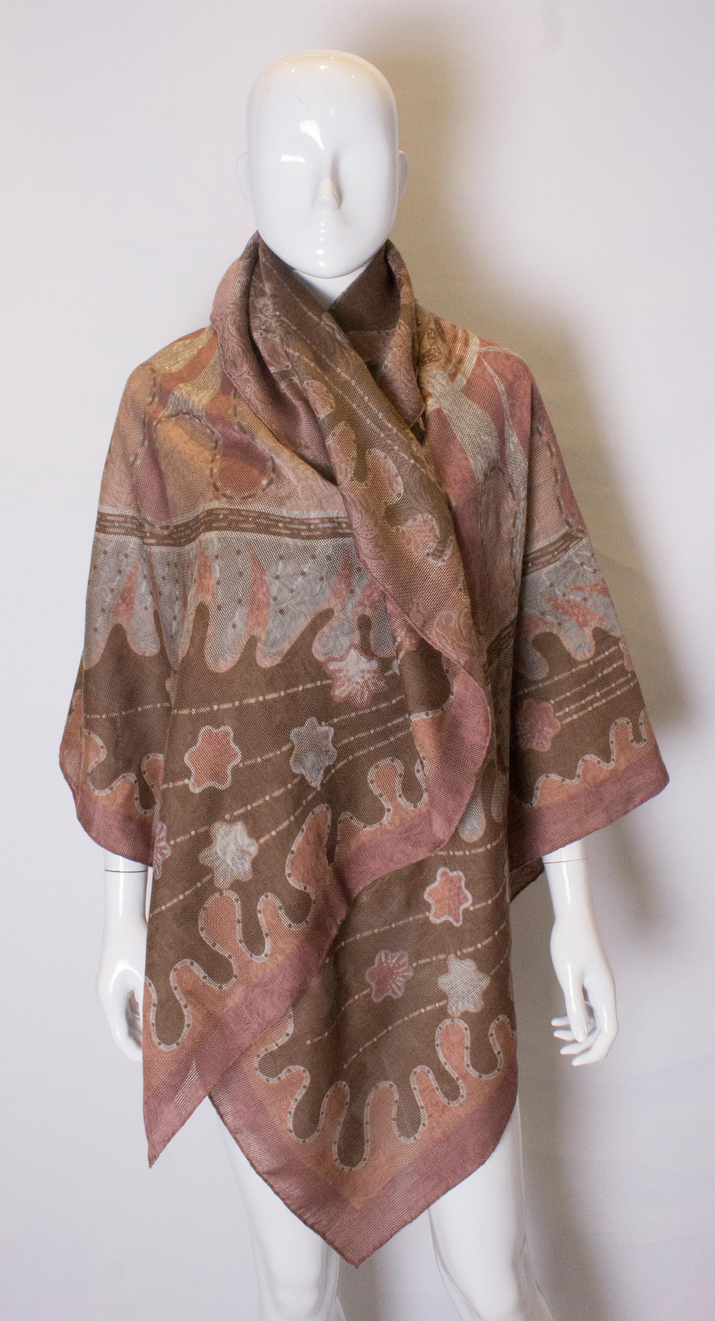 A large silk and wool  ( 70 % WOOL, 30 % silk ) shawl by Zandra Rhodes. The shawl is in a pretty plum and grey colour with pattern. It has  hand rolled edges, and was made in Italy.
Measurements: width 56'', length 110''

