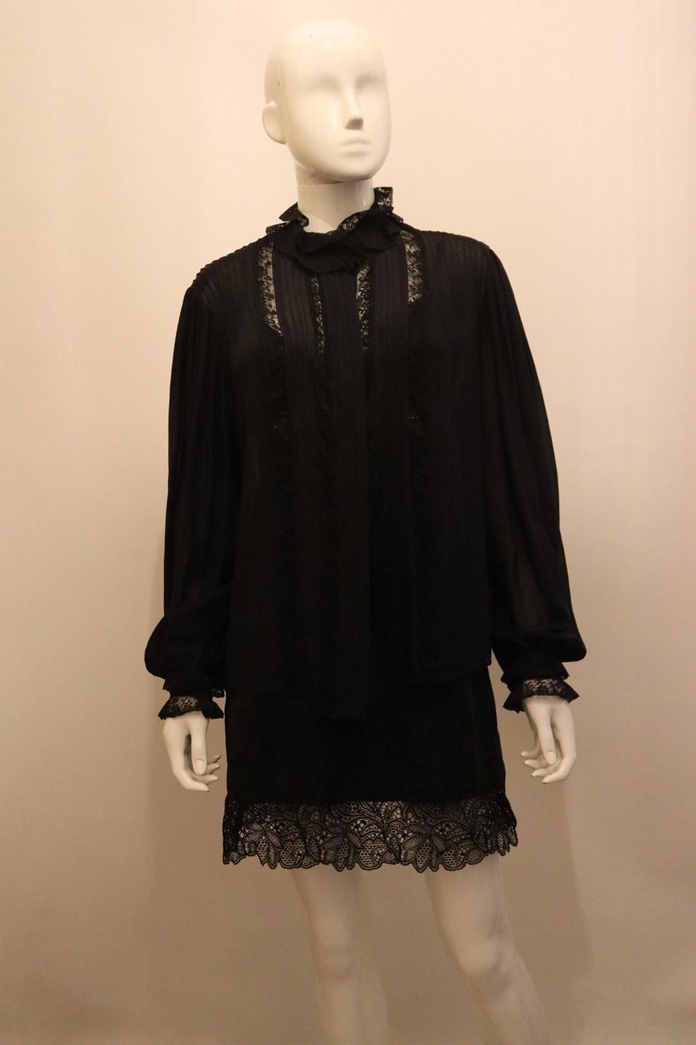 A very pretty vintage silk blouse with lace detail. 
The black blouse has pintuck and lace detail at the back, with two rows of lace at the cuff. The cuffs are two button , and there pintucks on the front .
Measurements: Bust up to 43'', length 22''