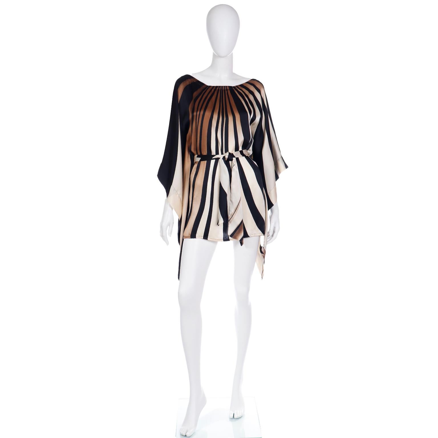 We love this fabulous silk striped caftan style top! This incredible vintage piece is in opaque shades of brown, black and ivory with abstract stripes and a beautiful silhouette! The sleeves are a variation on angle sleeves and the wide, boat neck