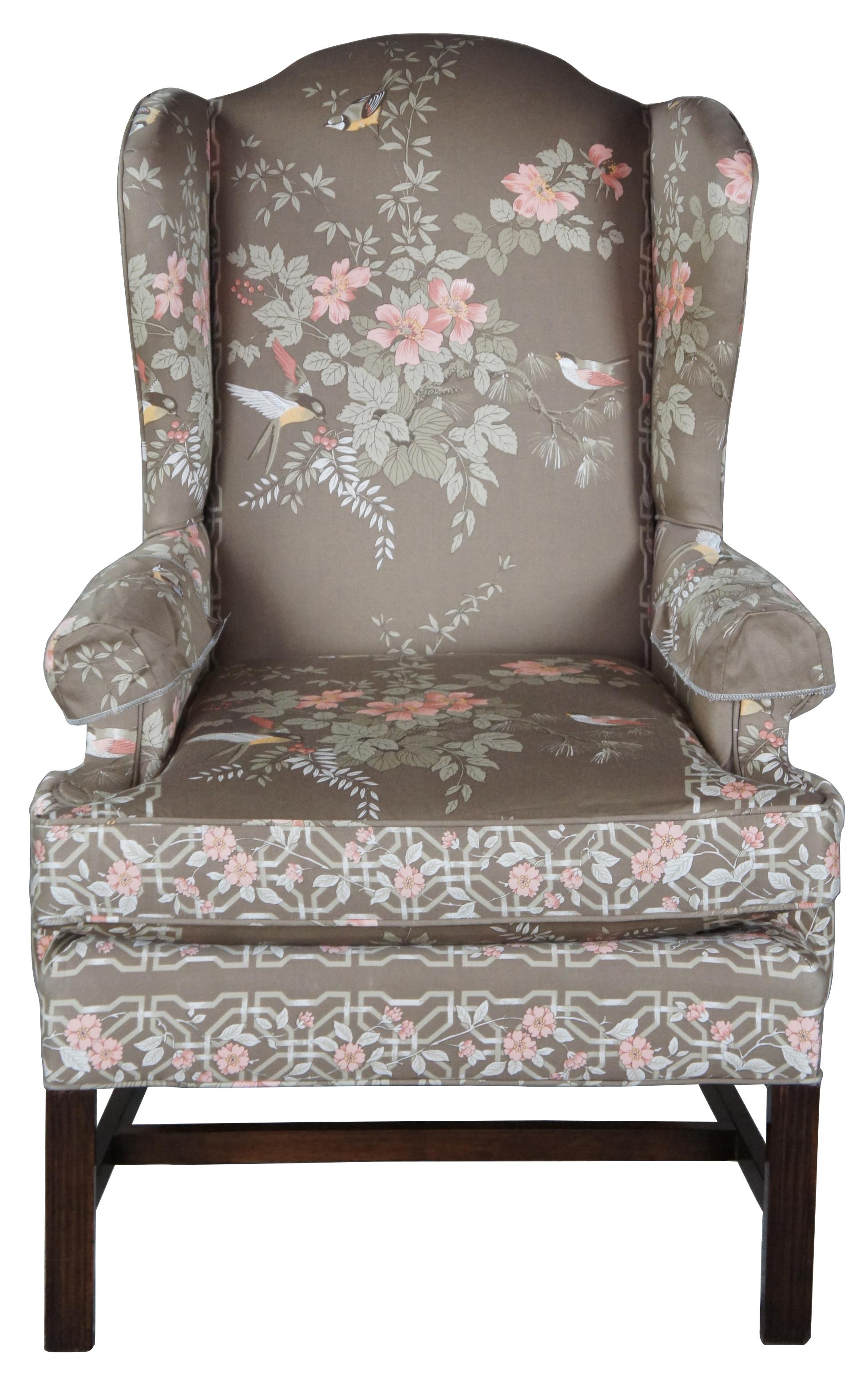 Chippendale style wingback chair, circa 1980s. Made from mahogany in North Carolina. Features a silk upholstery with hummingbirds and flowers.