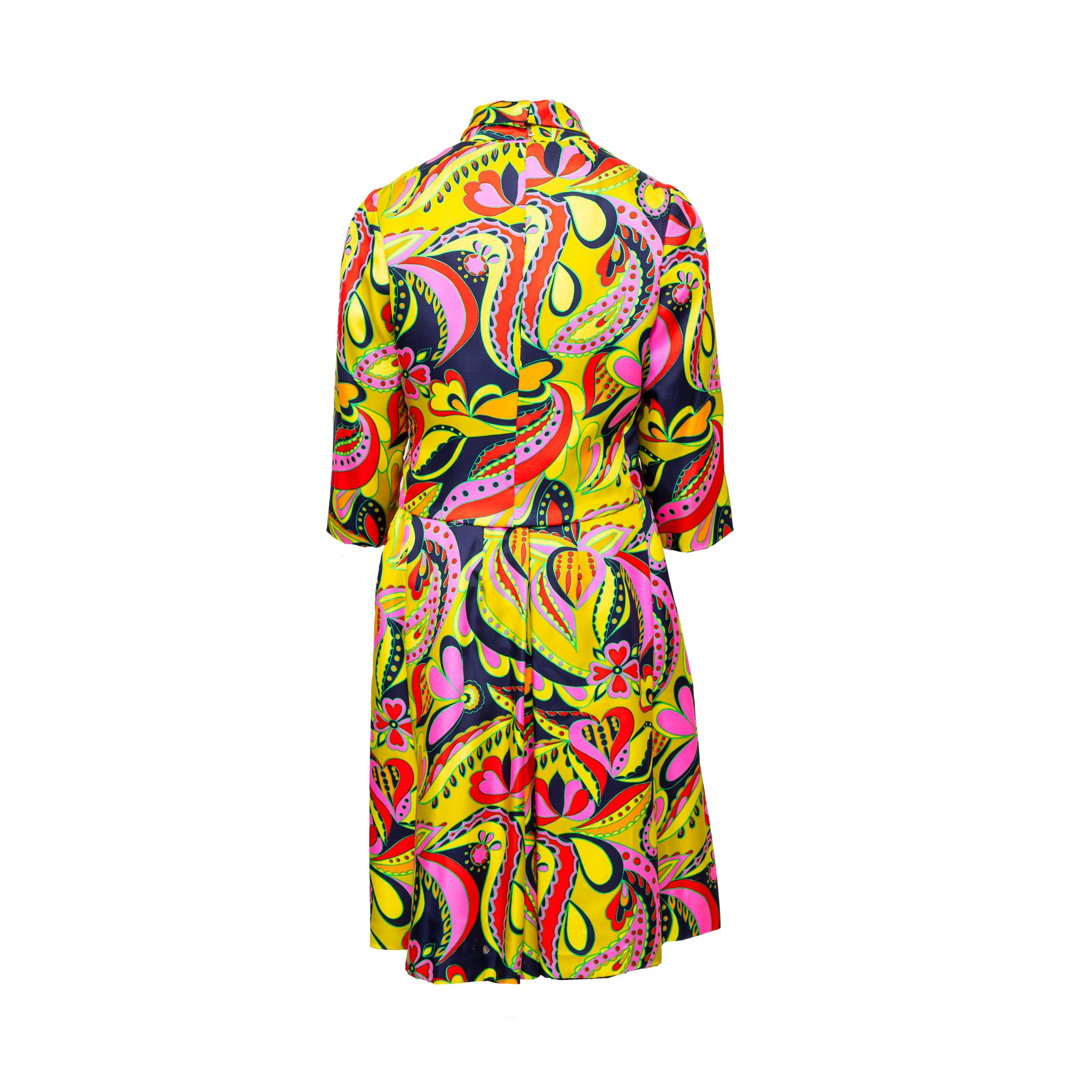 Elevate your wardrobe with this one-of-a-kind vintage silk dress and jacket set from the 90s. The dress boasts a high neck with a halter cut and pleated waist for a flattering silhouette, while the jacket has quarter sleeves, round collar, and front