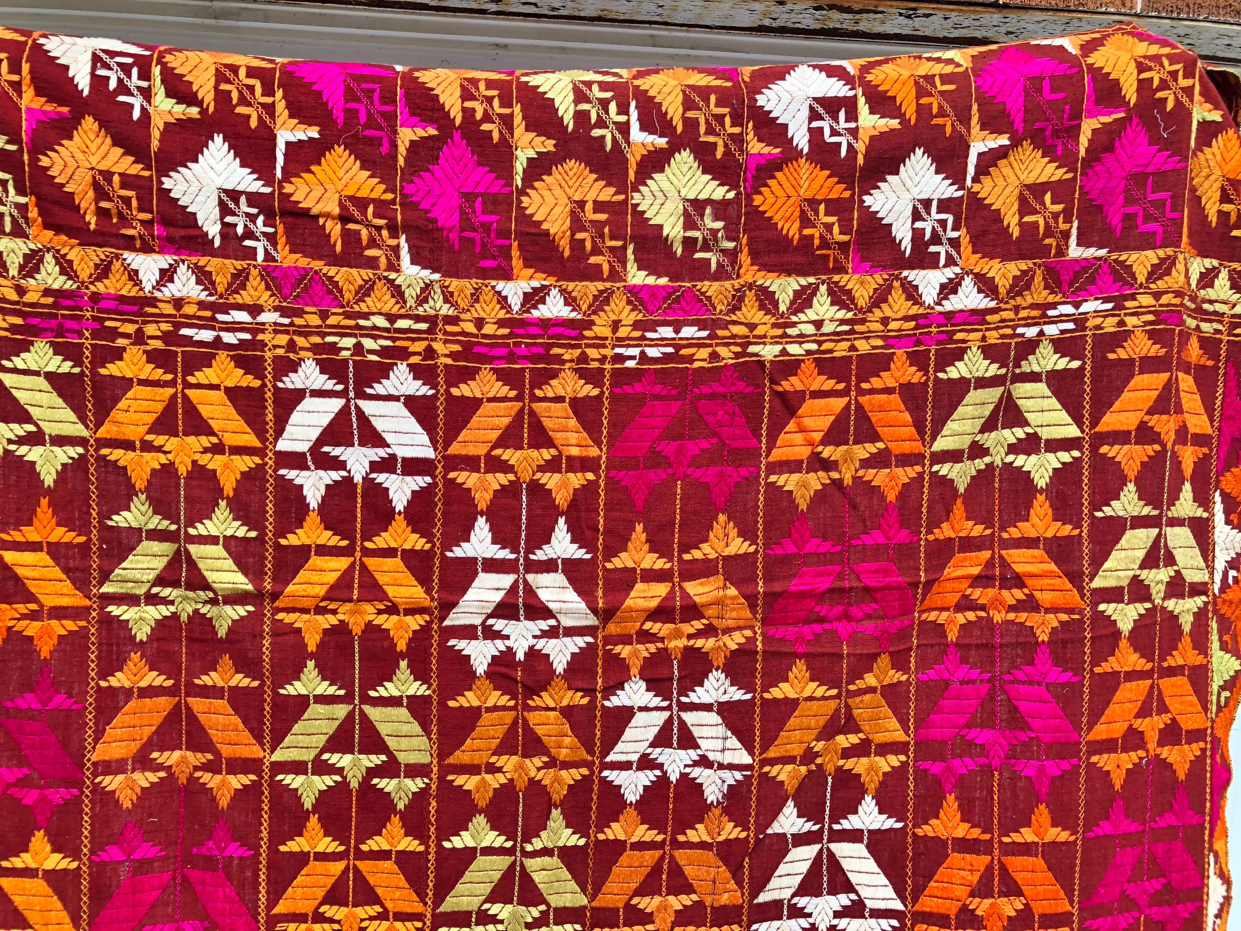Vintage silk embroidered Phulkari wedding shawl from Punjab, India. The shawl is handwoven cotton khadi cloth that is hand embroidered with vibrant silk threads. Made by relatives of the your girl for her wedding and other special occasions. The
