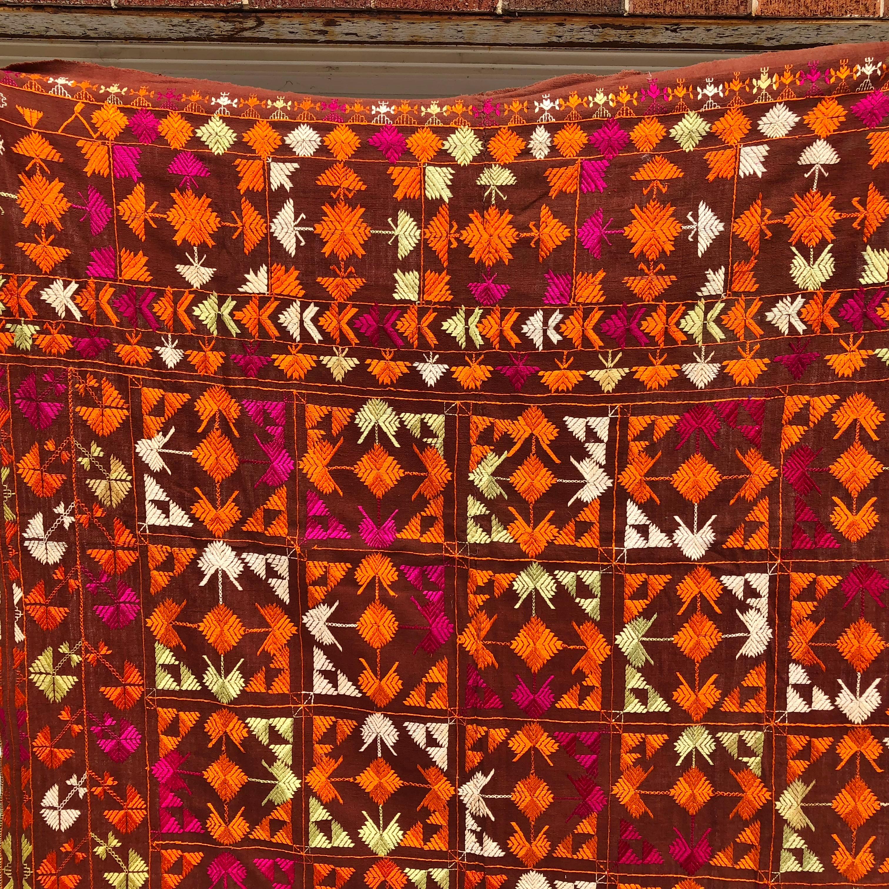 Vintage Phulkari wedding shawl from Punjab, India. The textile is hand loomed cotton khadi cloth that is hand embroidered with vibrant silk threads by relatives of the young girl's family for her wedding and other special occasions. The shawl is in