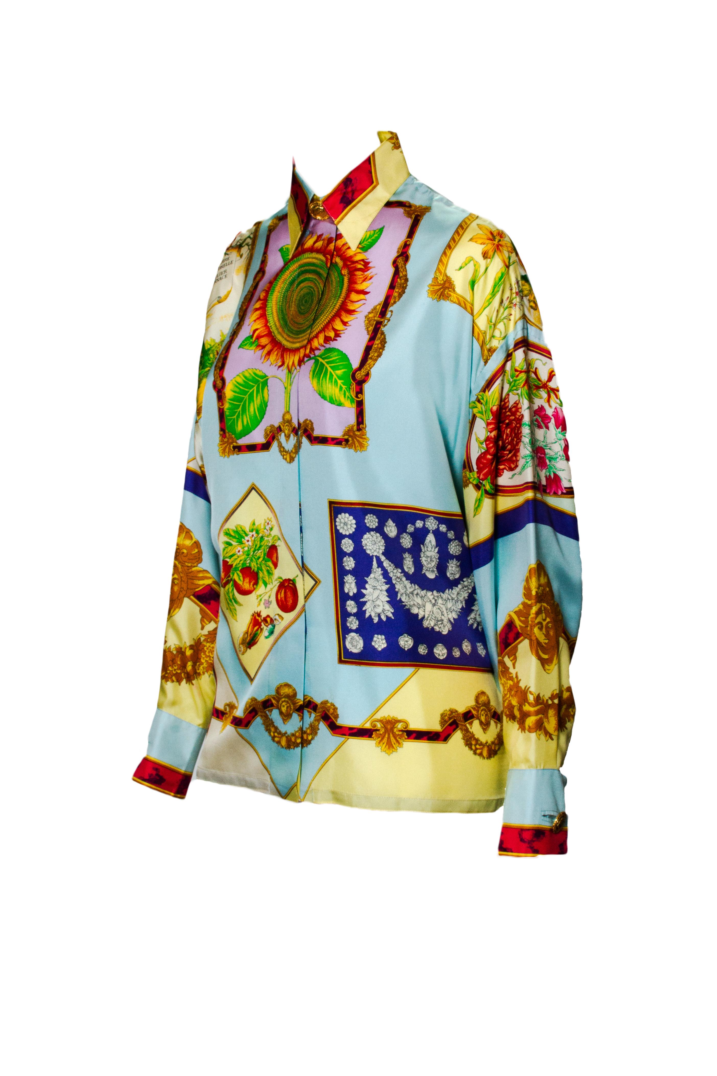 This bright silk collared shirt features an Atelier Versace original print. With large flowers on the front and back of the blouse, other images on the shirt include flora and fauna themes. The shirt additionally has a baroque theme throughout.