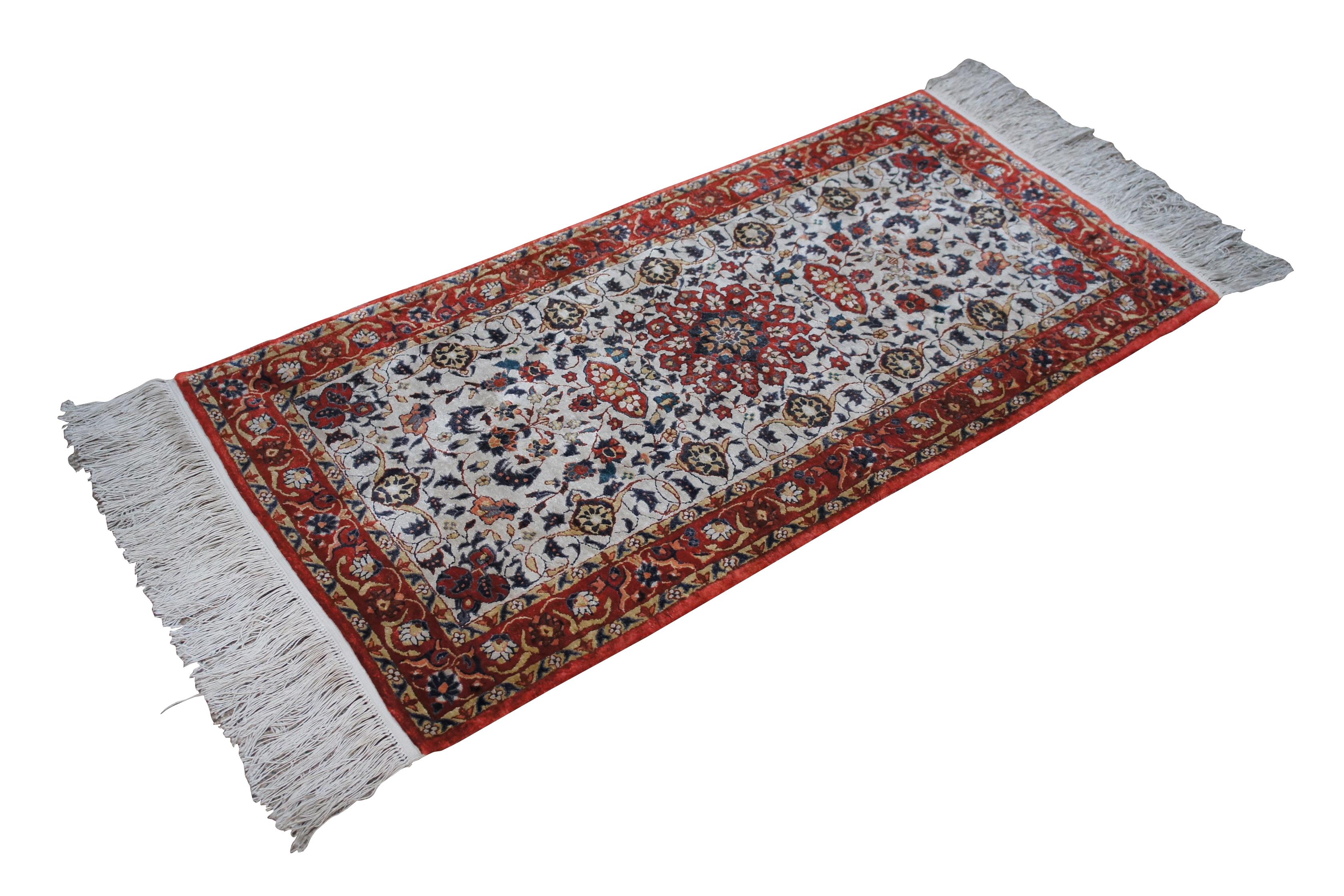 20th century hand knotted silk area rug / prayer mat with a thick plush pile and long fringe, decorated with a floral all over medallion design in white, red, and blue.

Dimensions:
50