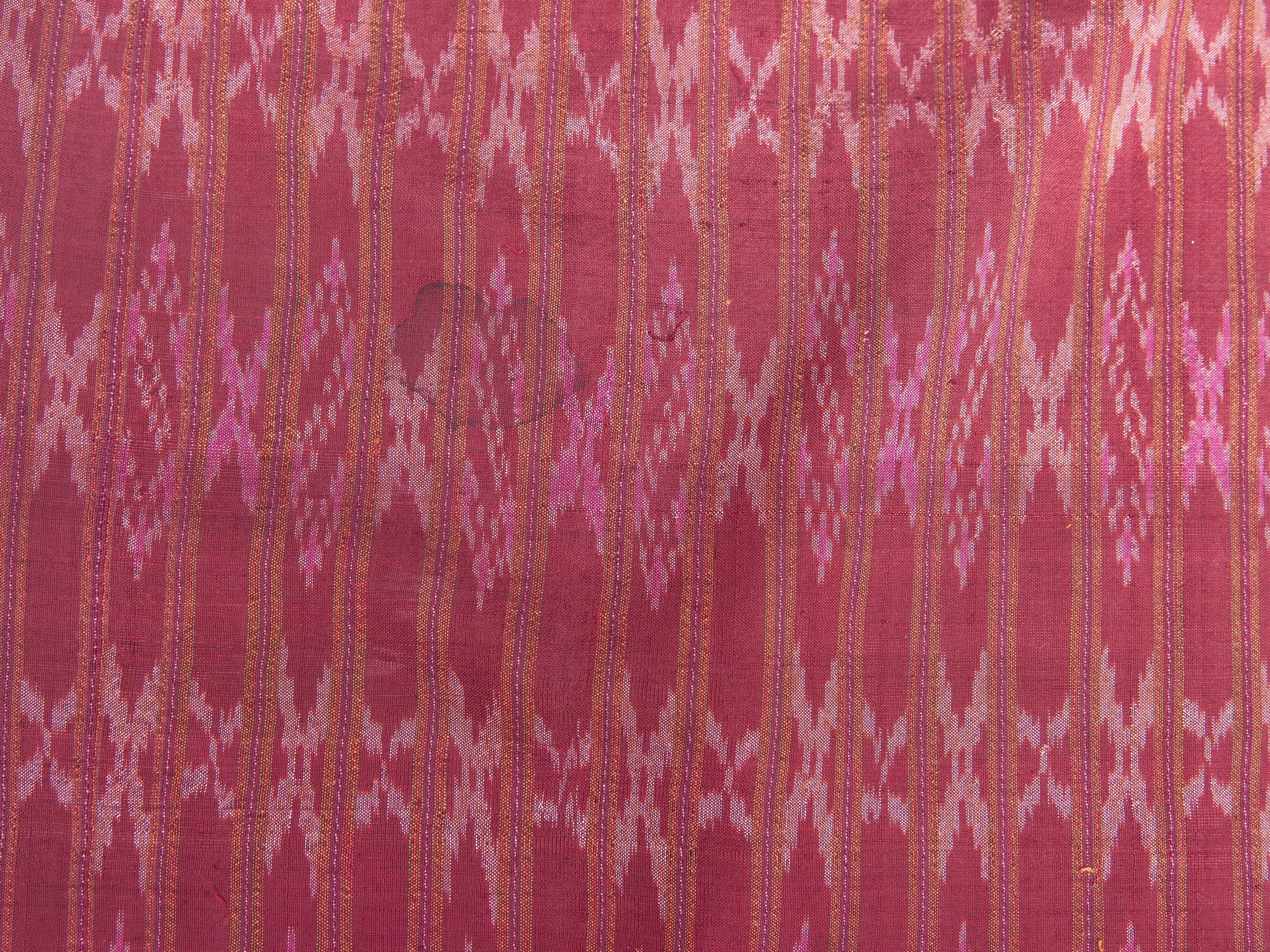 Vintage silk Ikat Sarong from East Thailand or Cambodia, mid-20th century.
This sarong comes from the border region of Thailand and Cambodia. The coloration and close repeating pattern are typical for this area. A single length of the handwoven