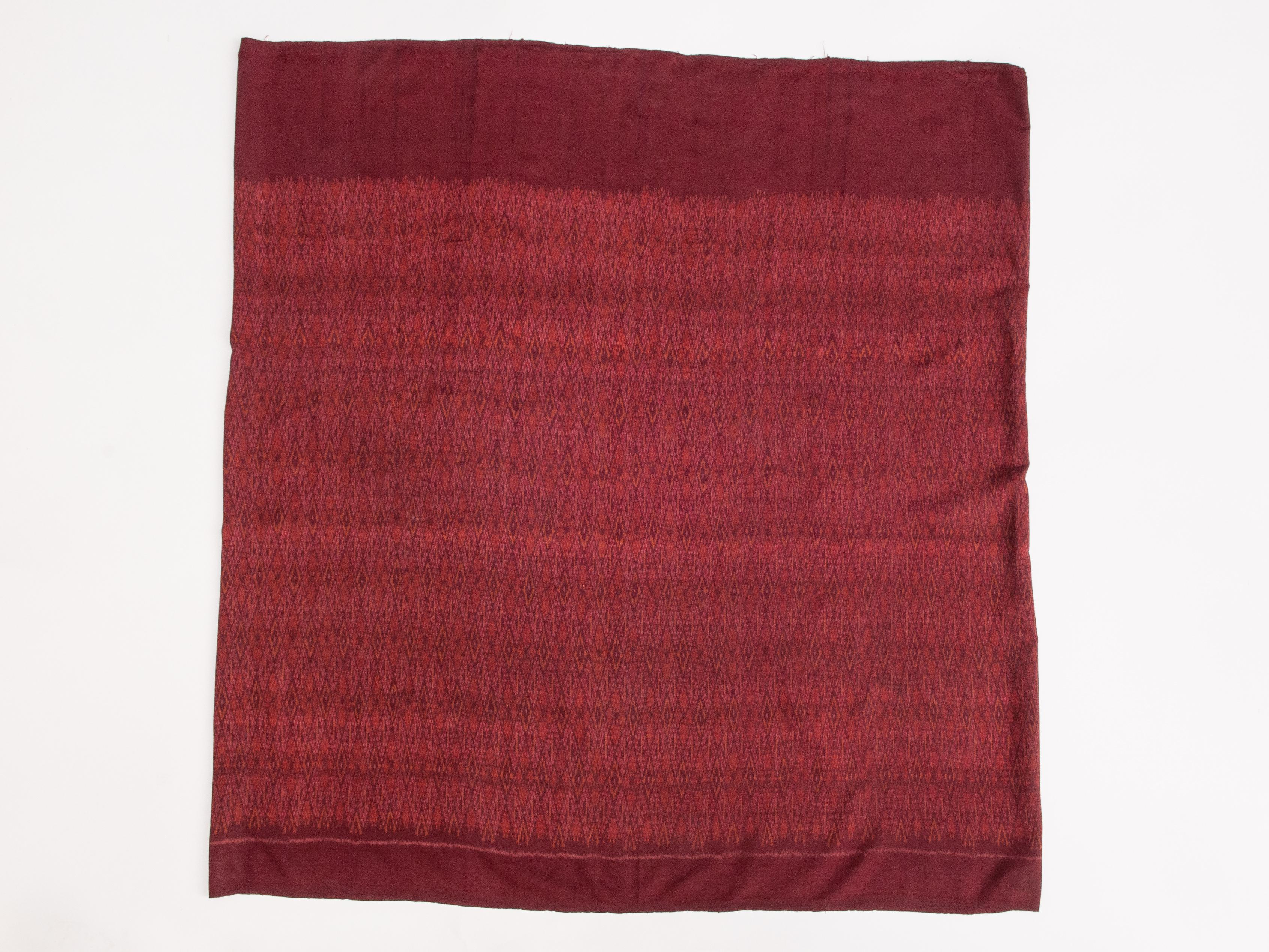 Vintage silk Ikat Sarong from East Thailand or Cambodia, mid-20th century.
This sarong comes from the border region of Thailand and Cambodia. The coloration and close repeating pattern are typical for this area. A single length of the handwoven