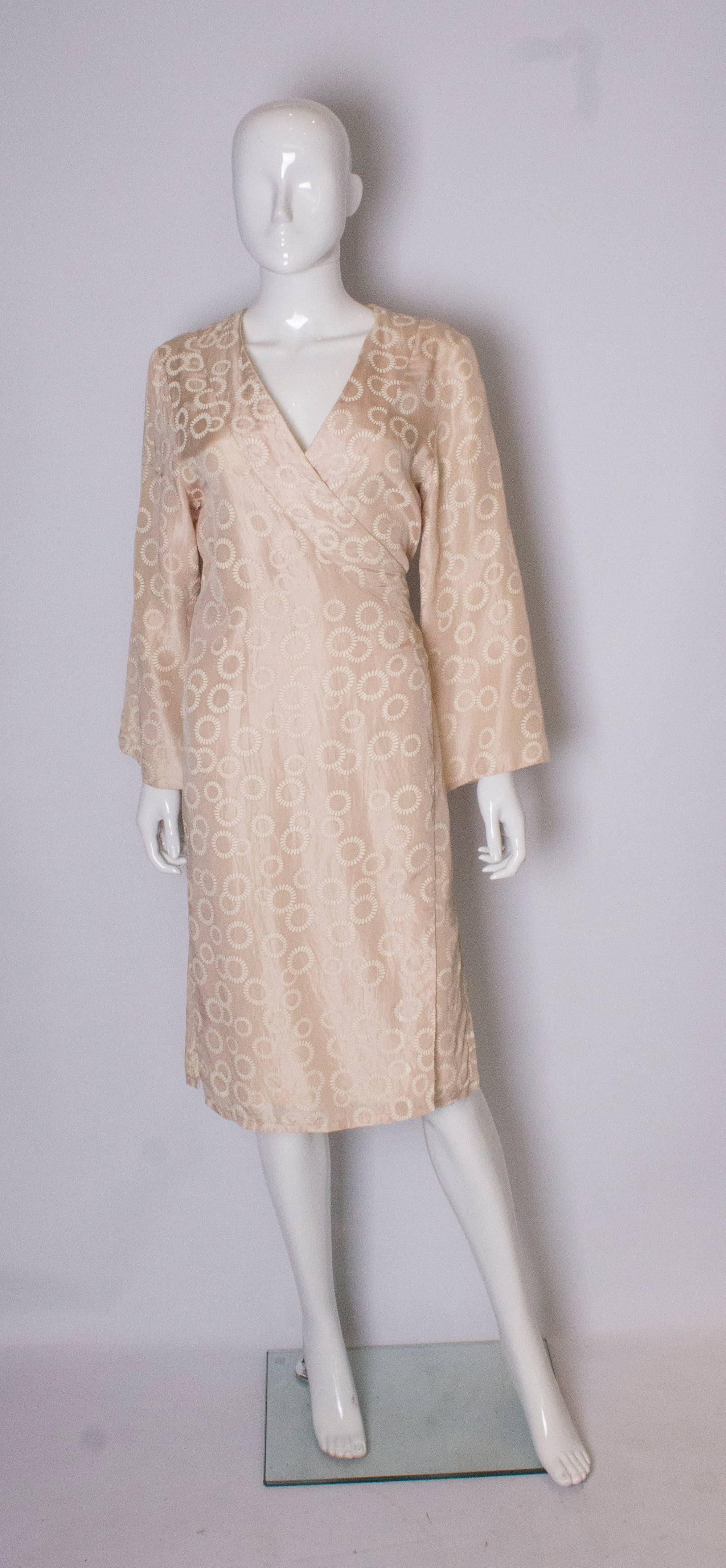 A silk wrapover, kimono style dress. The outer silk is a pale biscuit colour with a floral design, the lining is silk. The ties tie at the back.
Bust up to 38/39'', length 45''.