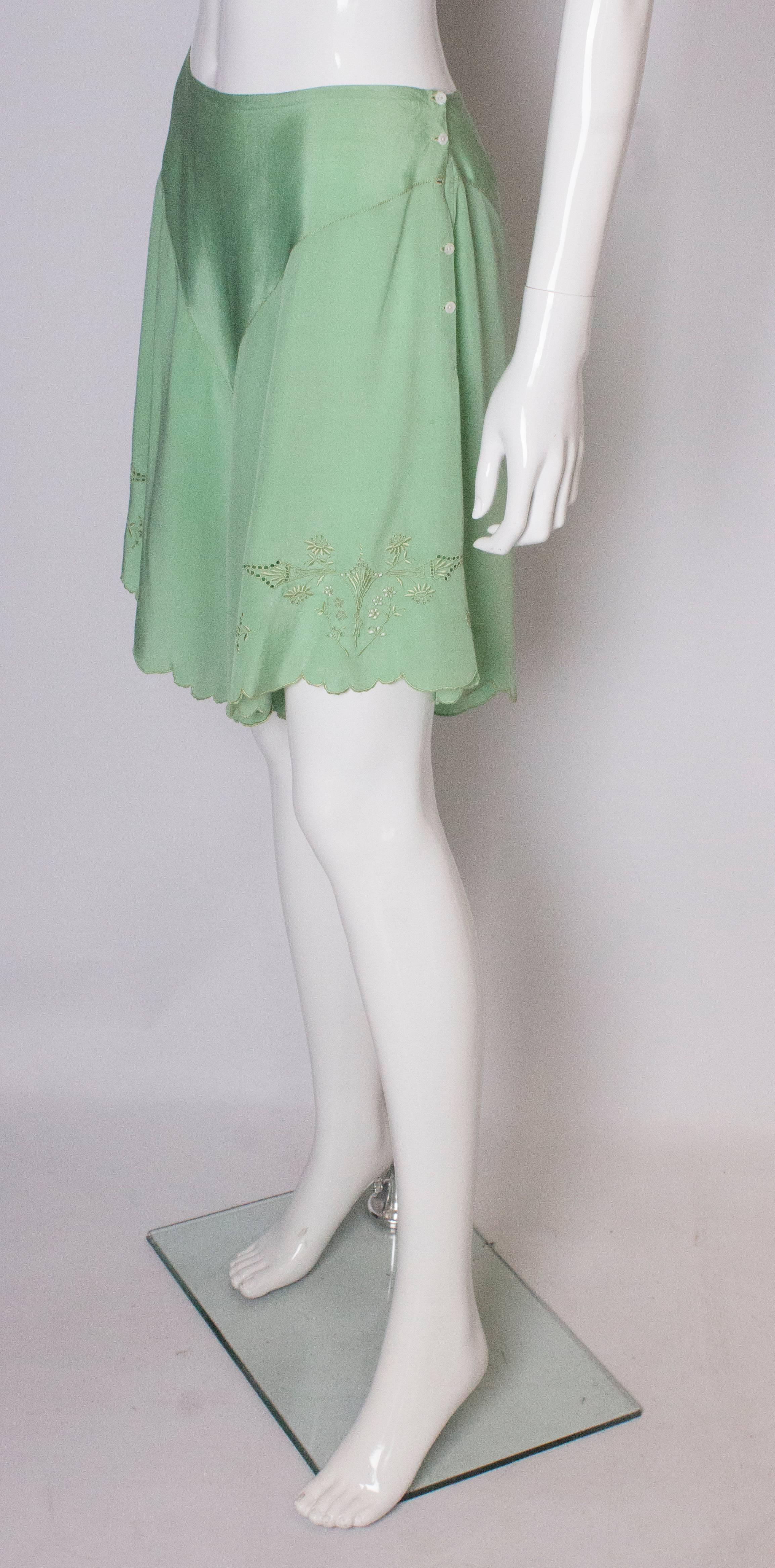 A pretty pair of vintage silk pants or shorts. They are in a green silk with scalloped hem , embroidery and side button opening.