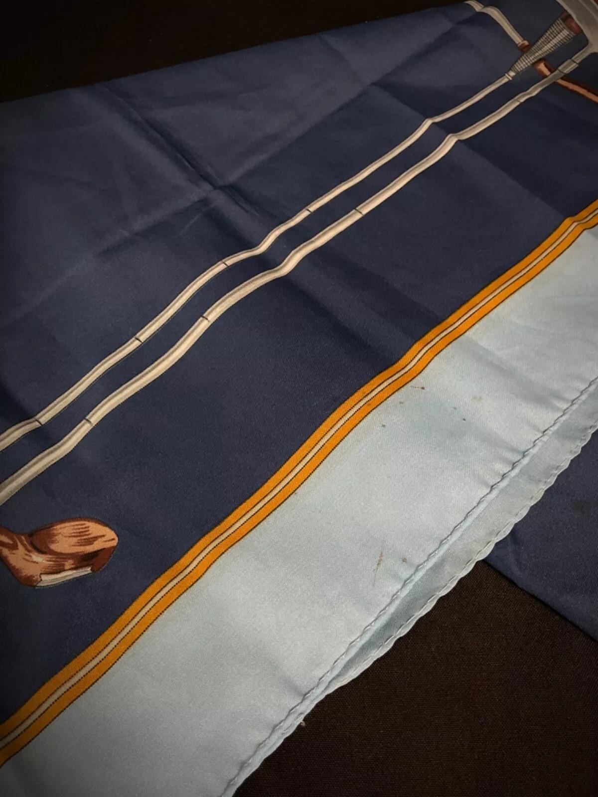 This vintage silk scarf by Auguste Renard features a charming golf theme, making it a stylish and unique addition to any wardrobe or collection. Measuring 27.6 inches (70 cm) in both height and length, this square scarf is an original piece from
