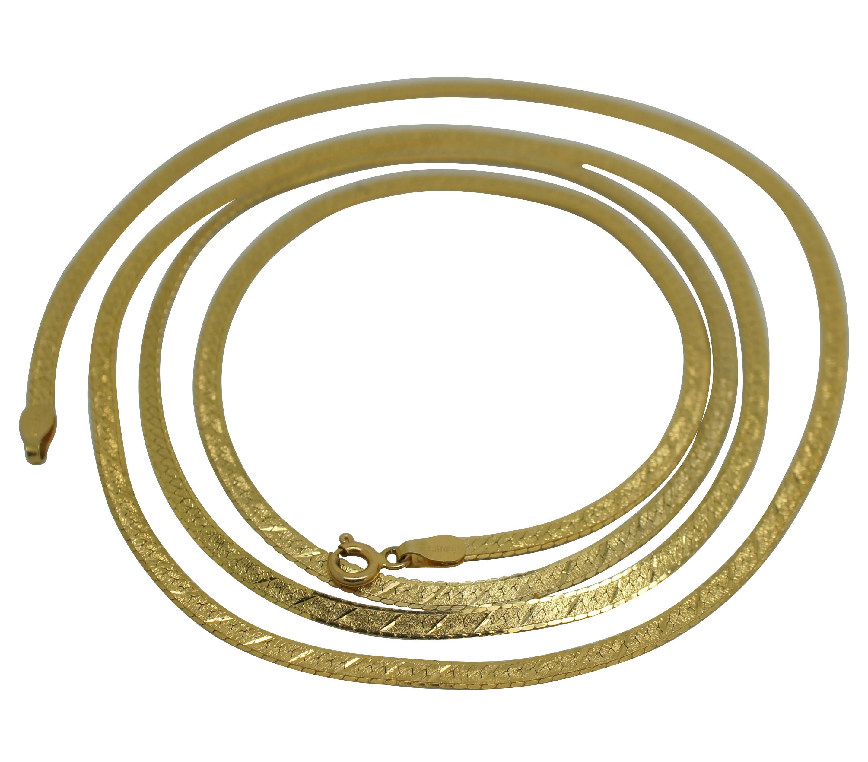 Vintage Silmar 14k yellow gold flat chain necklace in the herringbone design with a decorative texture and scalloped edge; spring ring clasp. Made in Italy.

30” x 0.125” / 3mm (Length x Width) / 8 g