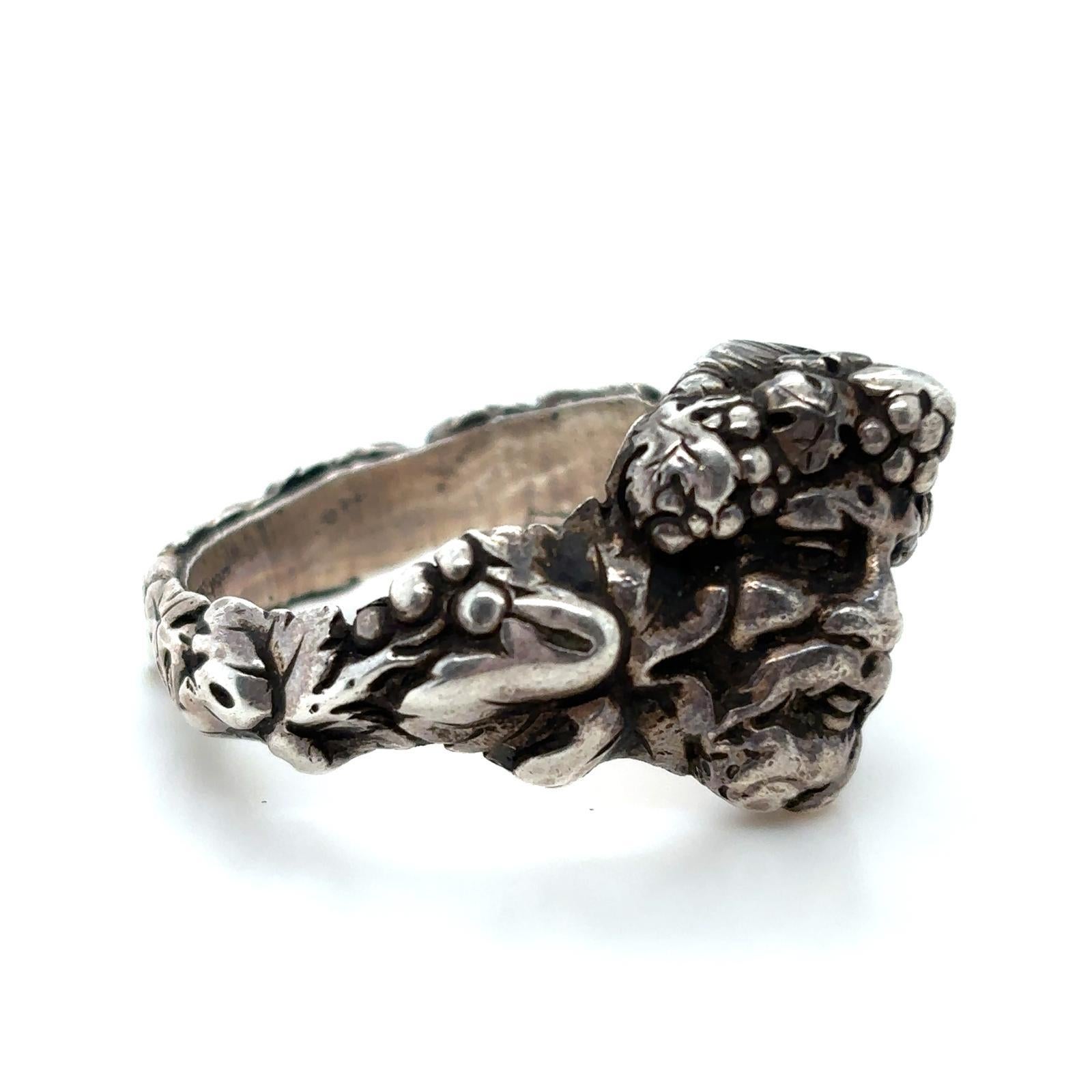A vintage silver Bacchus Greek God of wine ring, Circa 1960

This unusual ring is designed in the form of Bacchus the God of wine, depicting his face adorned in grapes to the front and set with futher fruit and vine leaves to the rest of the band.