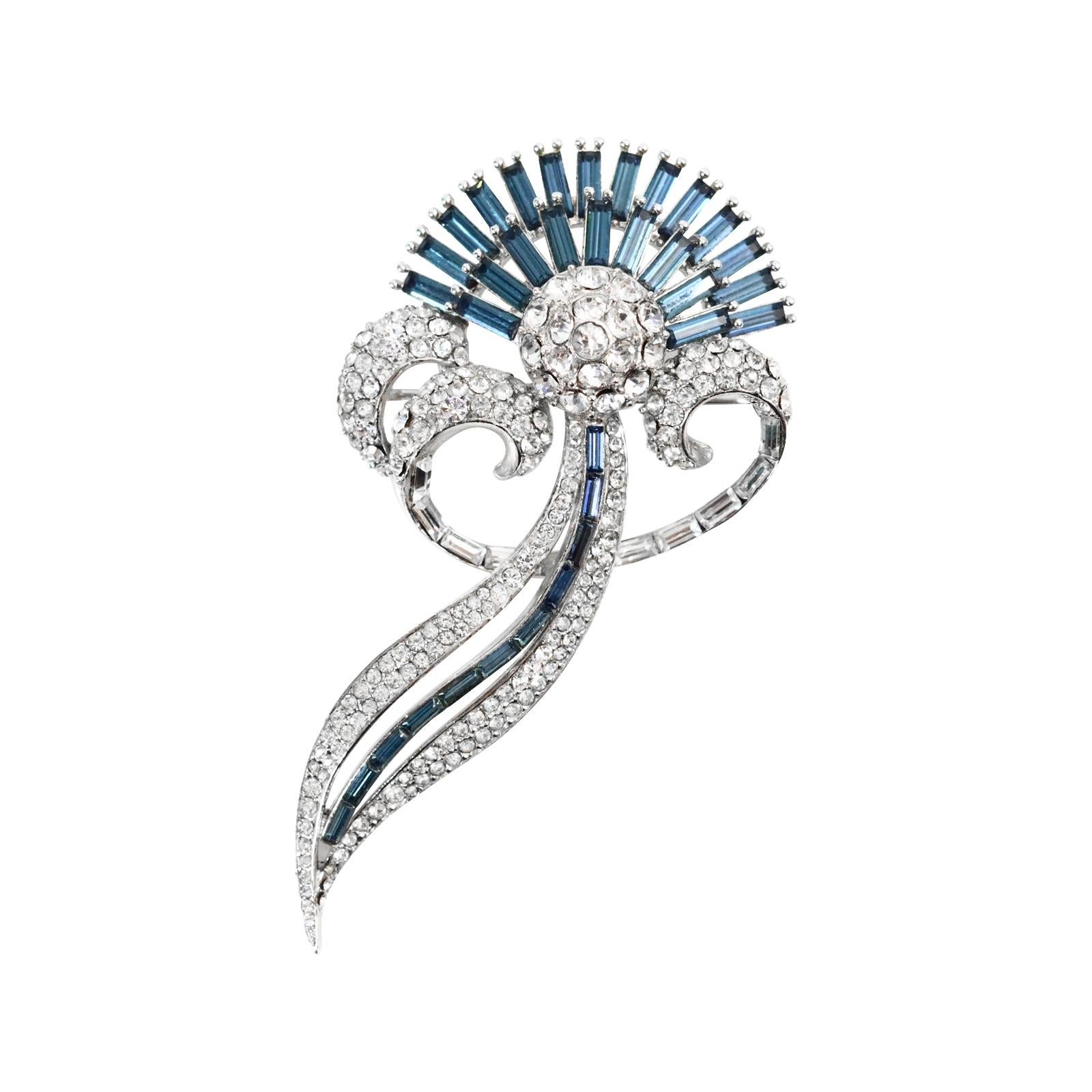 Vintage Silver Blue Sapphire Baguette and Pave Brooch Circa 1960s.  No one will know that you are wearing costune when you wear this gorgeous brooch. The fan like look of every crystal blue sapphire baguette is simply stunning against the pave