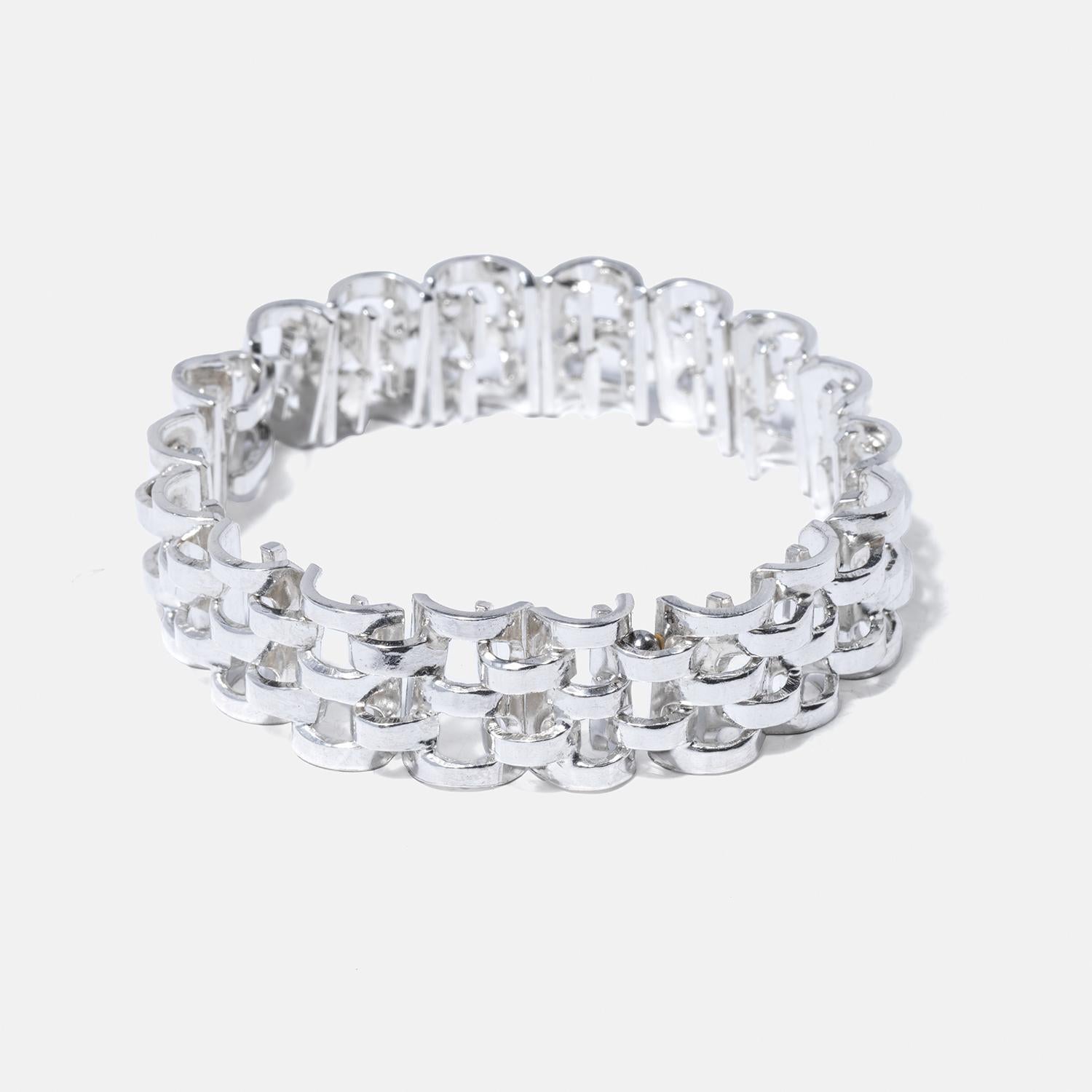 This elegant bracelet is crafted from sterling silver rectangles linked tightly to form a design reminiscent of chain mail. The links have a brilliant white sheen, bring a touch of radiant armor to any outfit. It closes easily with a hook, ensuring
