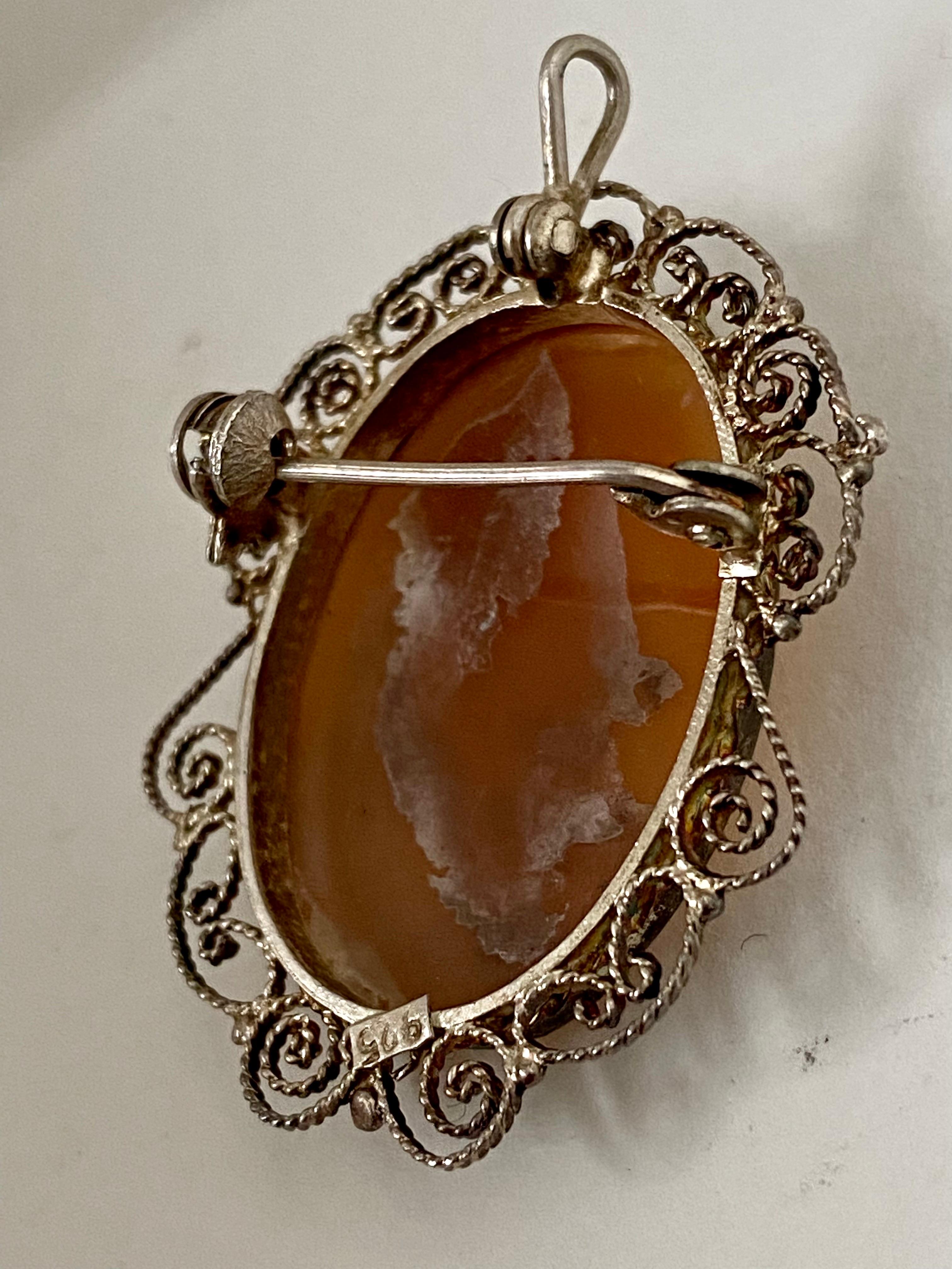 This beautiful piece is in good condition for its age. Visible signs of ageing and wear. It can be wear as a brooch or as pendant necklace. It does not come with a chain. It is 34mm long by 28mm wide. Please study the images carefully as form part