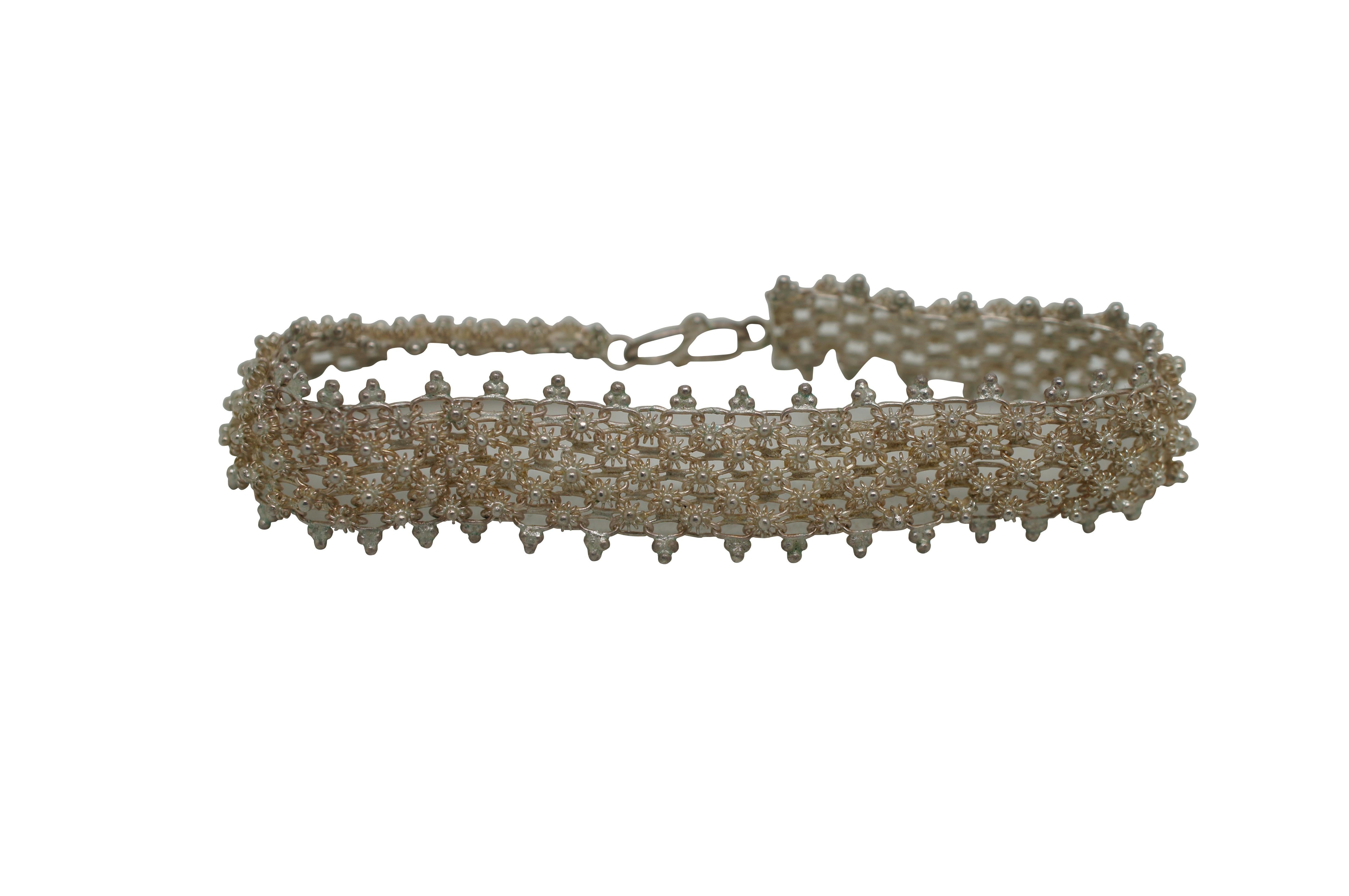 Vintage silver cannetille woven mesh bracelet featuring Etruscan revival Lao Dok Phikoun floral bead / ball design.  

The dok phikoun flower is stylistically rendered and integrated into each pattern. This flower has special meaning to Lao