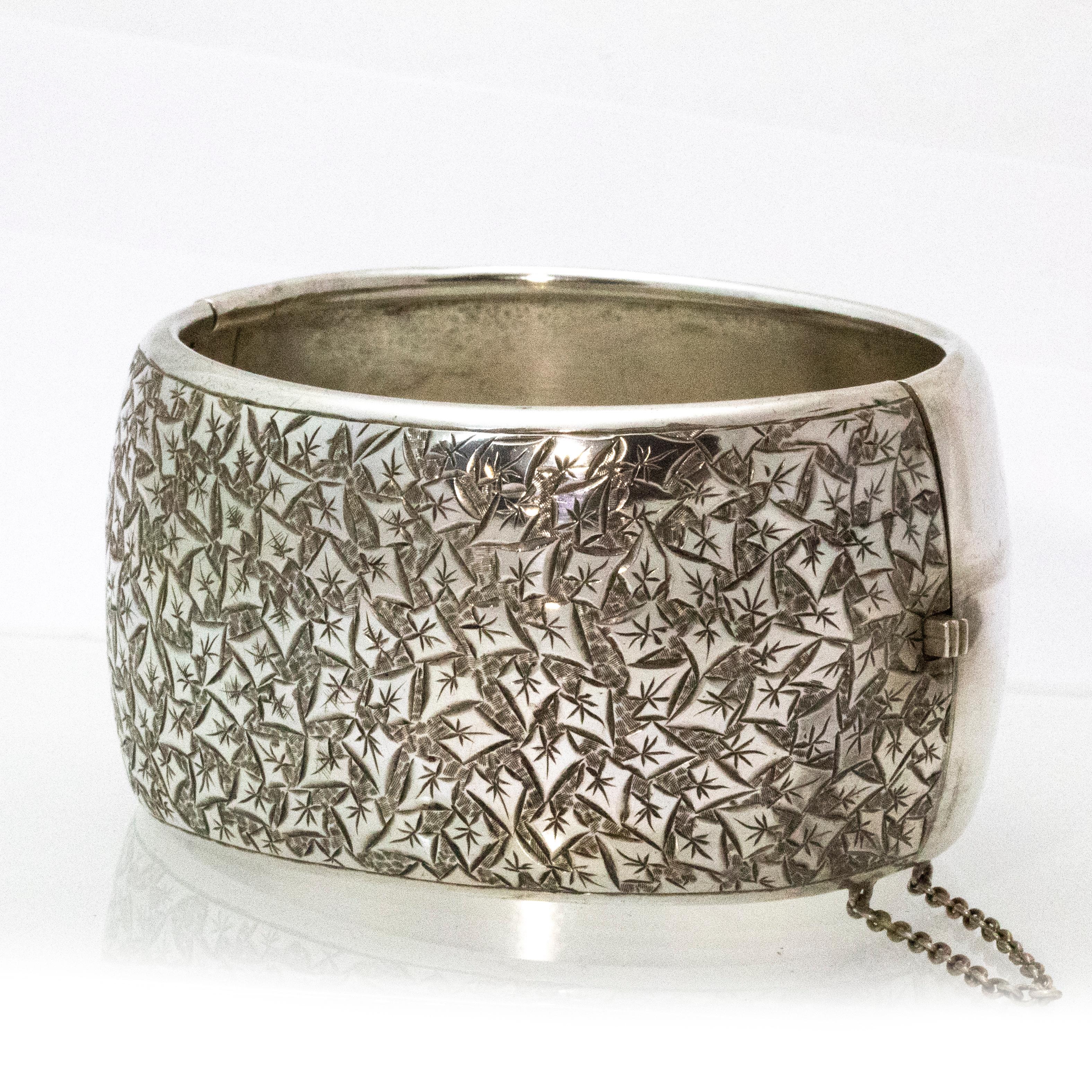 Finely detailed extra wide silver bangle. The engraving is beautifully intricate and really eye catching.